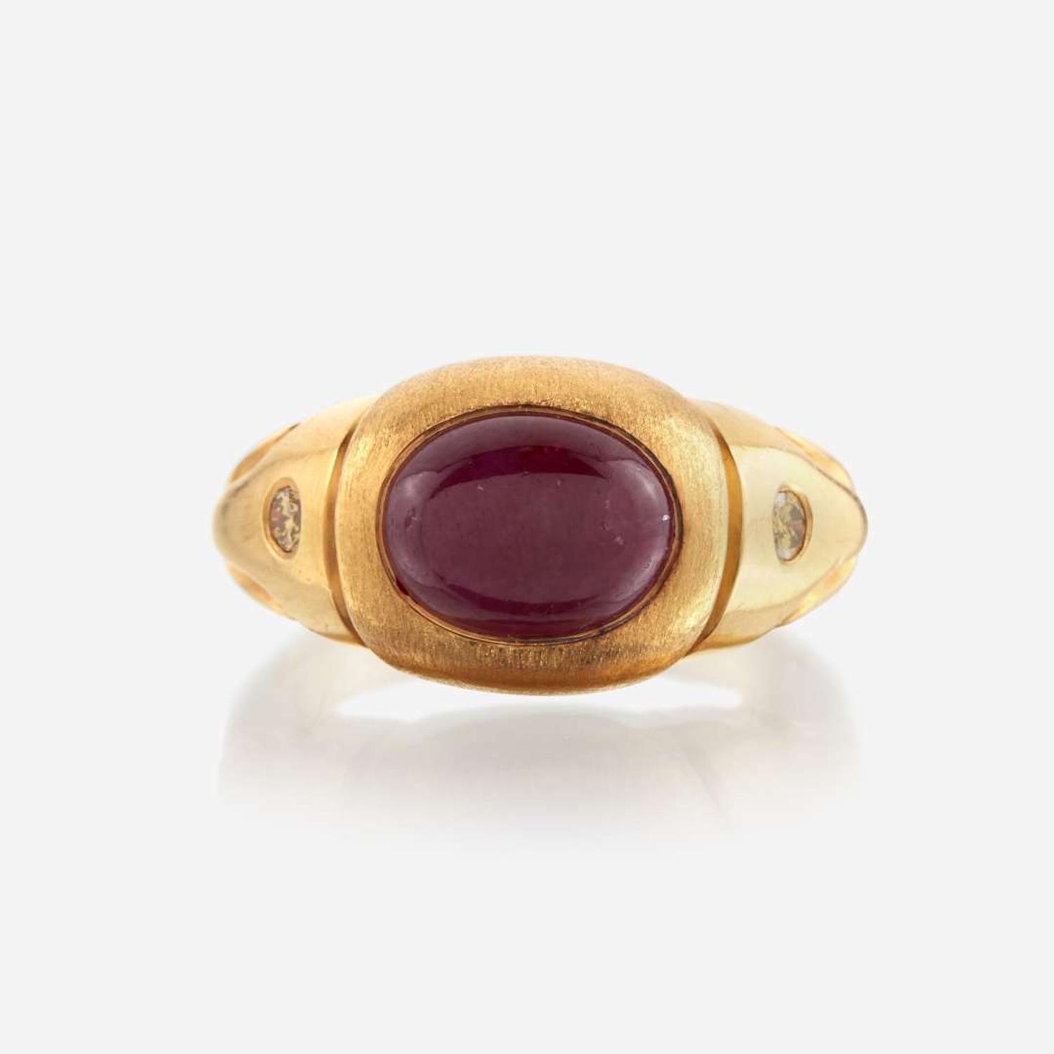 A twenty-two karat gold, ruby, and colored diamond ring