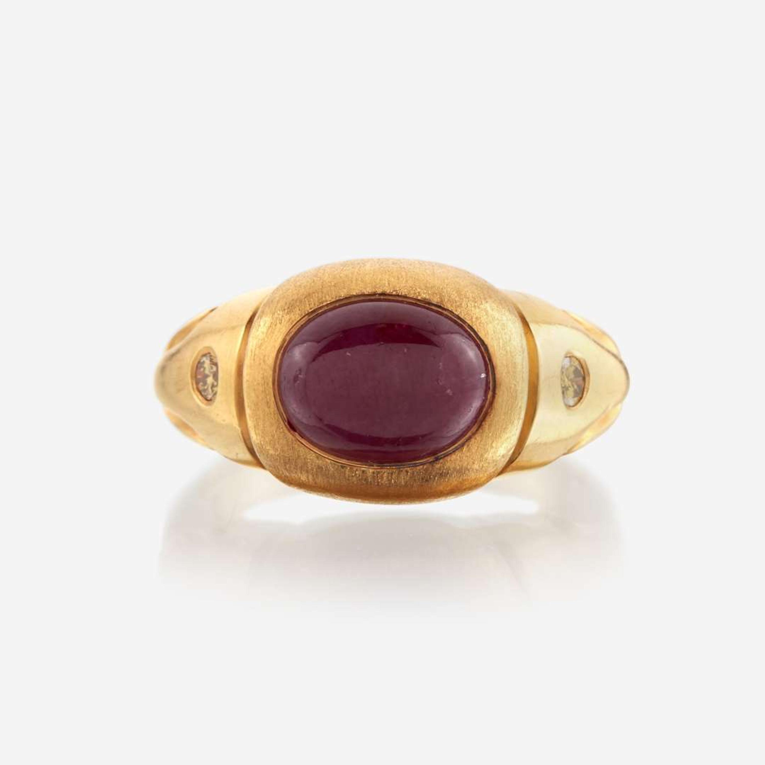 A twenty-two karat gold, ruby, and colored diamond ring