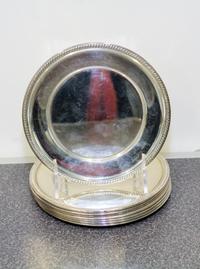 A Set of Eight American Silver Bread Plates, Hunt Silver Co., Chicago, IL, having gadrooned rims.