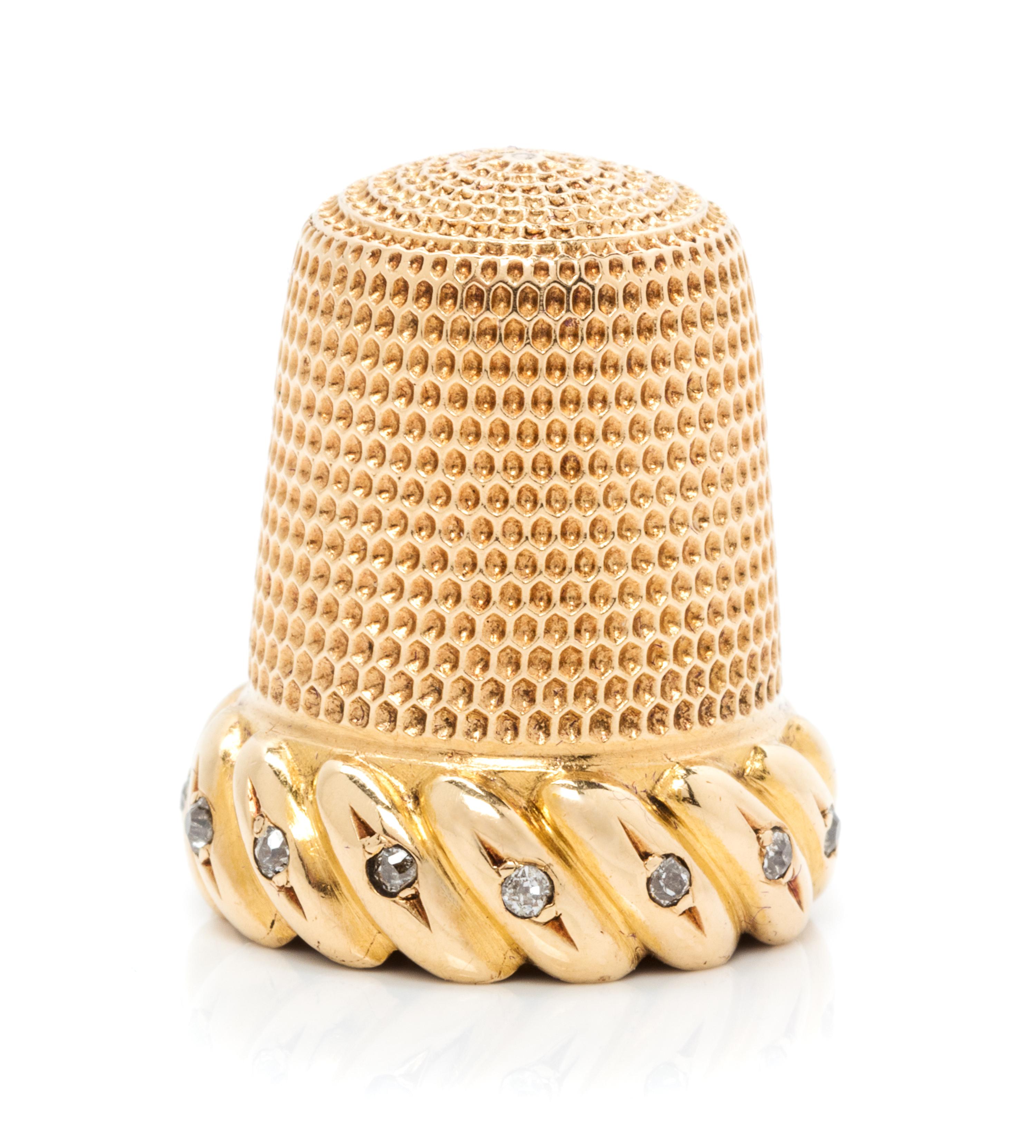 An American 18-Karat Gold and Diamond Thimble, Simons Brothers Co., Philadephia, PA, the knurled top and body above a gadroon band inse