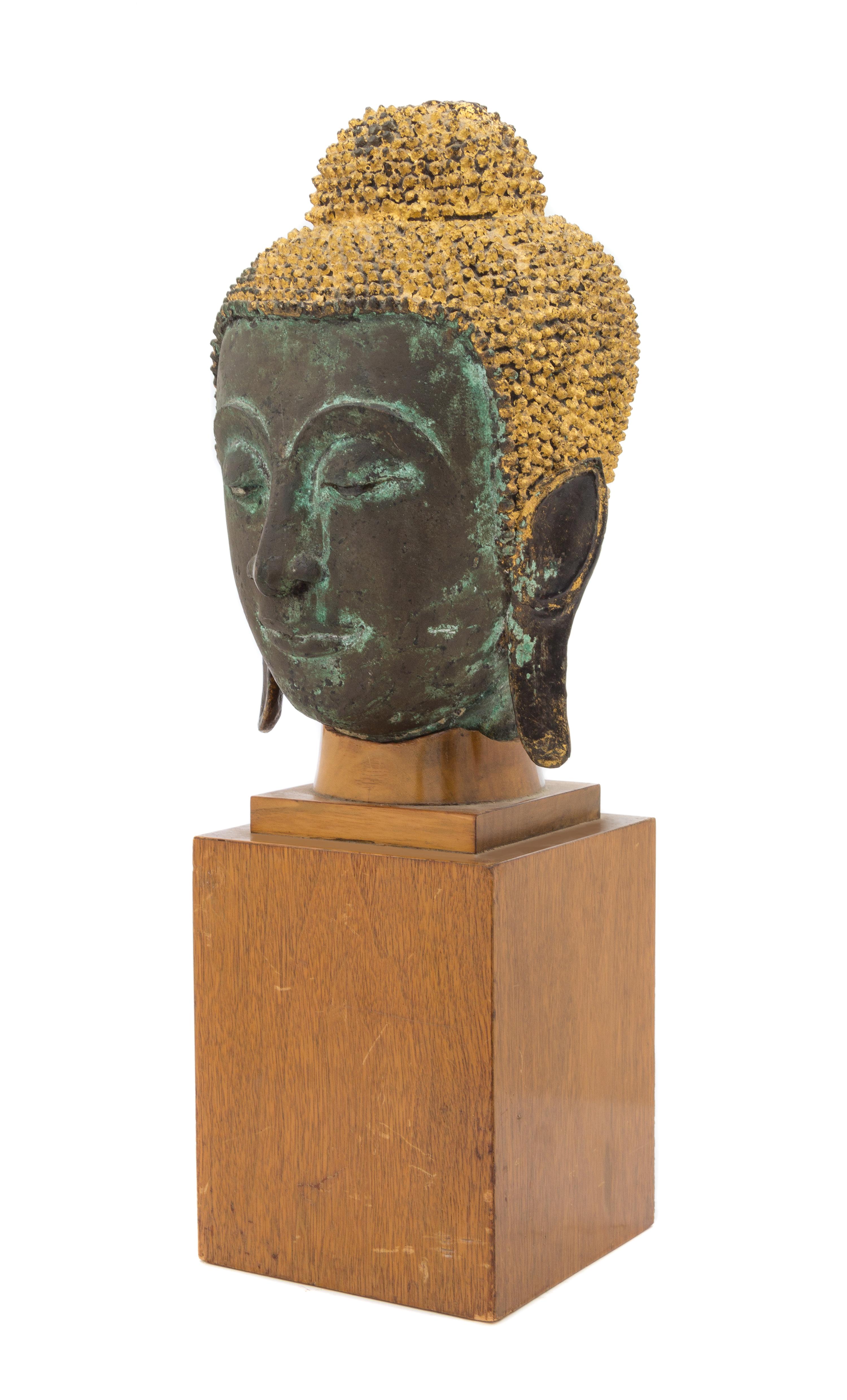 A Thai Parcel Gilt Bronze Buddha Head 18TH CENTURY OR EARLIER Height of head 12 1/2 inches. — 18TH CENTURY OR EARLIER