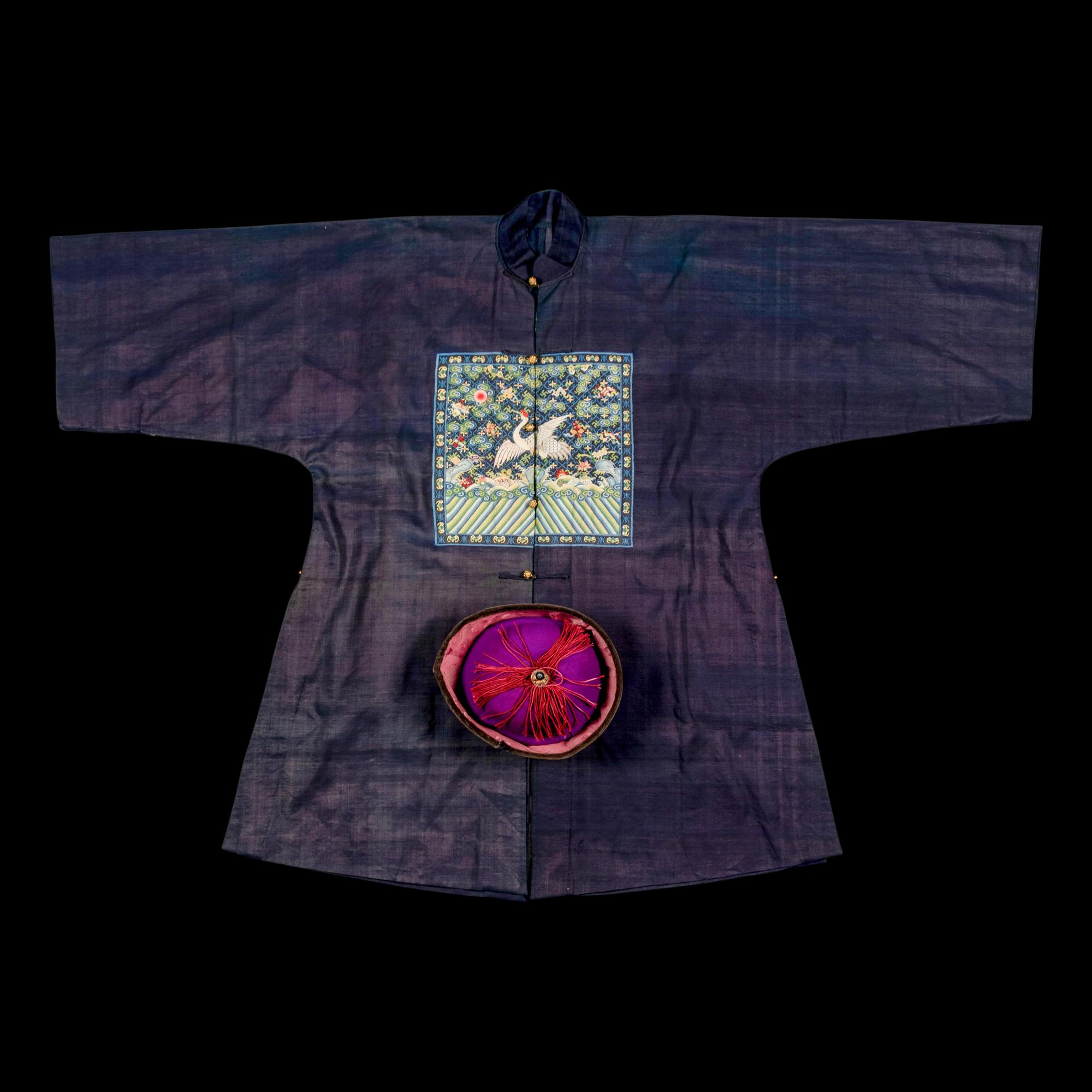 A Chinese Navy Blue Ground Official's Surcoat, Bufu, and A Velvet-Brimmed Winter Hat, Jiguan, 19th Century 清中晚期 藍地一品文官補服及冬吉冠一頂