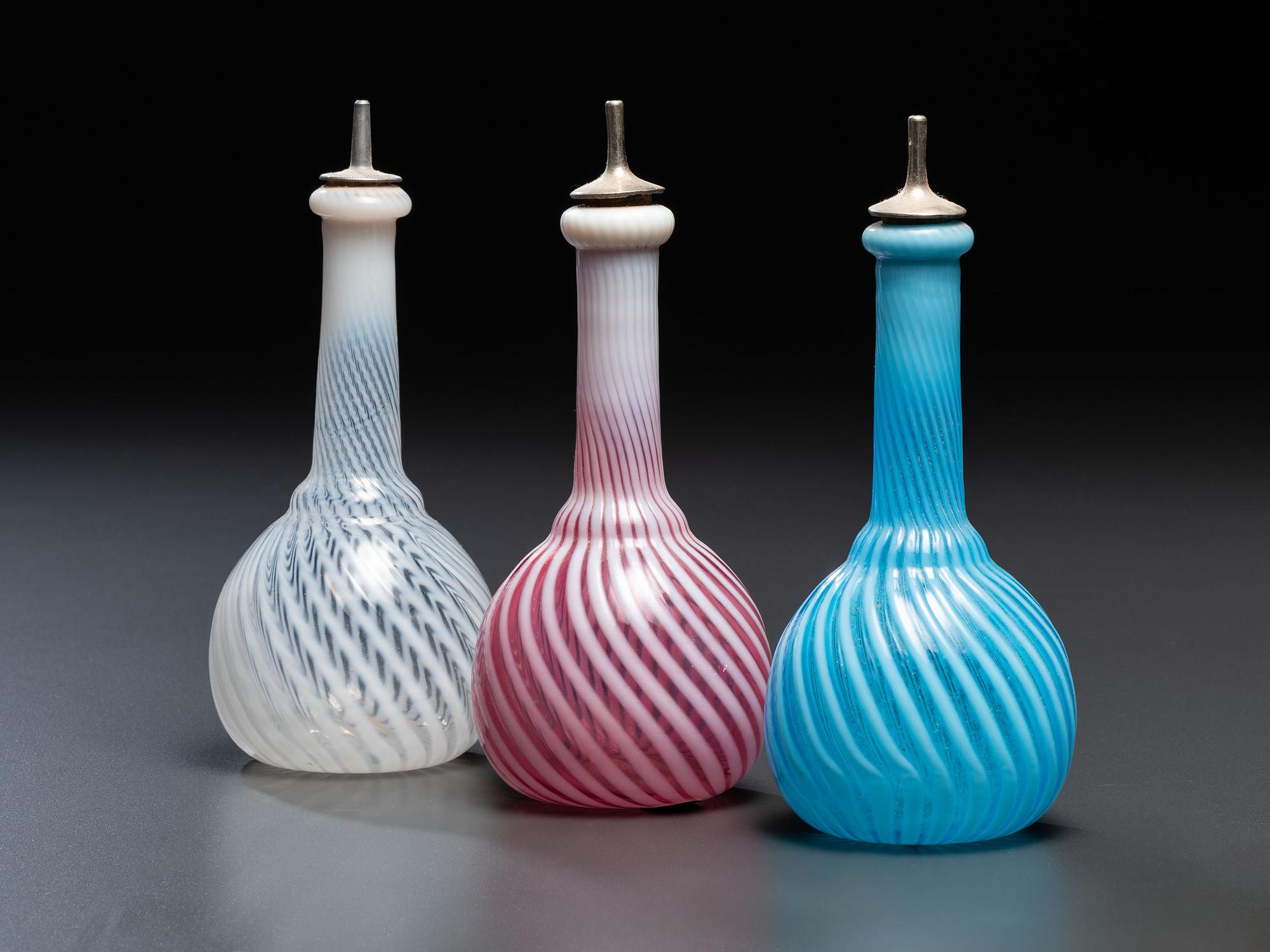 Three Opalescent Swirl Glass Barber Bottles