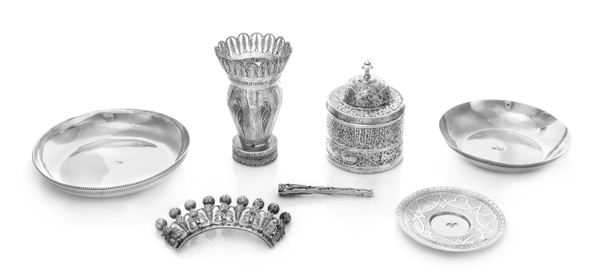 A Collection of Seven Middle Eastern Silver Articles, Various Makers, comprising a filligree vase, hair ornament and cigarette, togethe