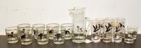 A Set of Game Decorated Glasses Height of pitcher 9 1/8 inches.