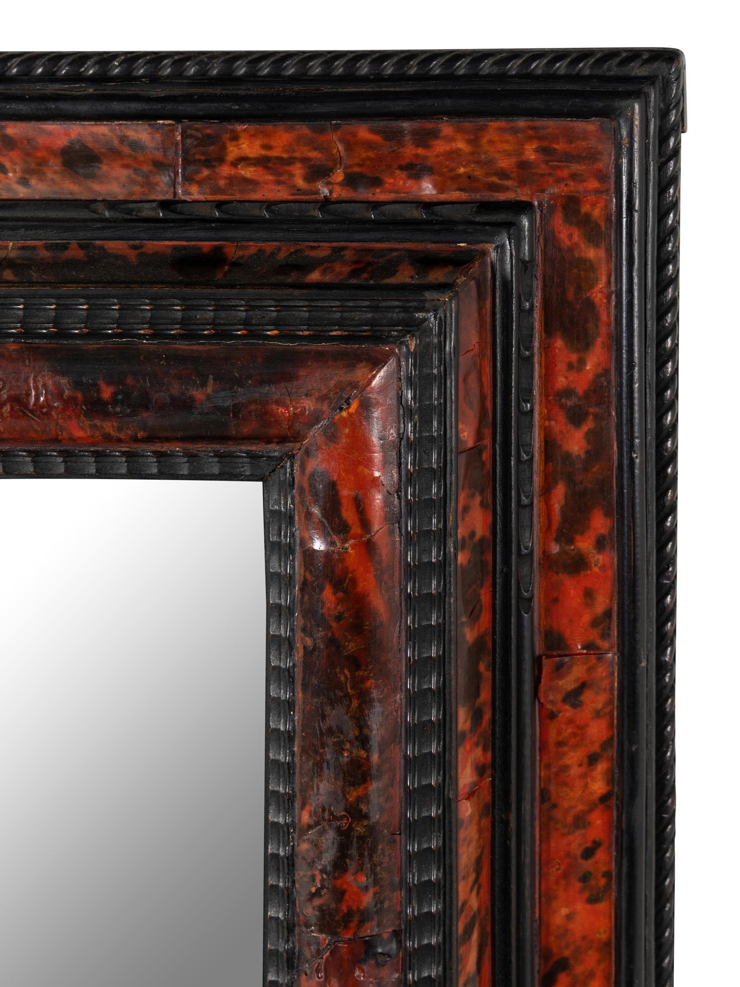A Dutch Tortoise Shell Veneered and Ripple-Molded Ebonized Mirror