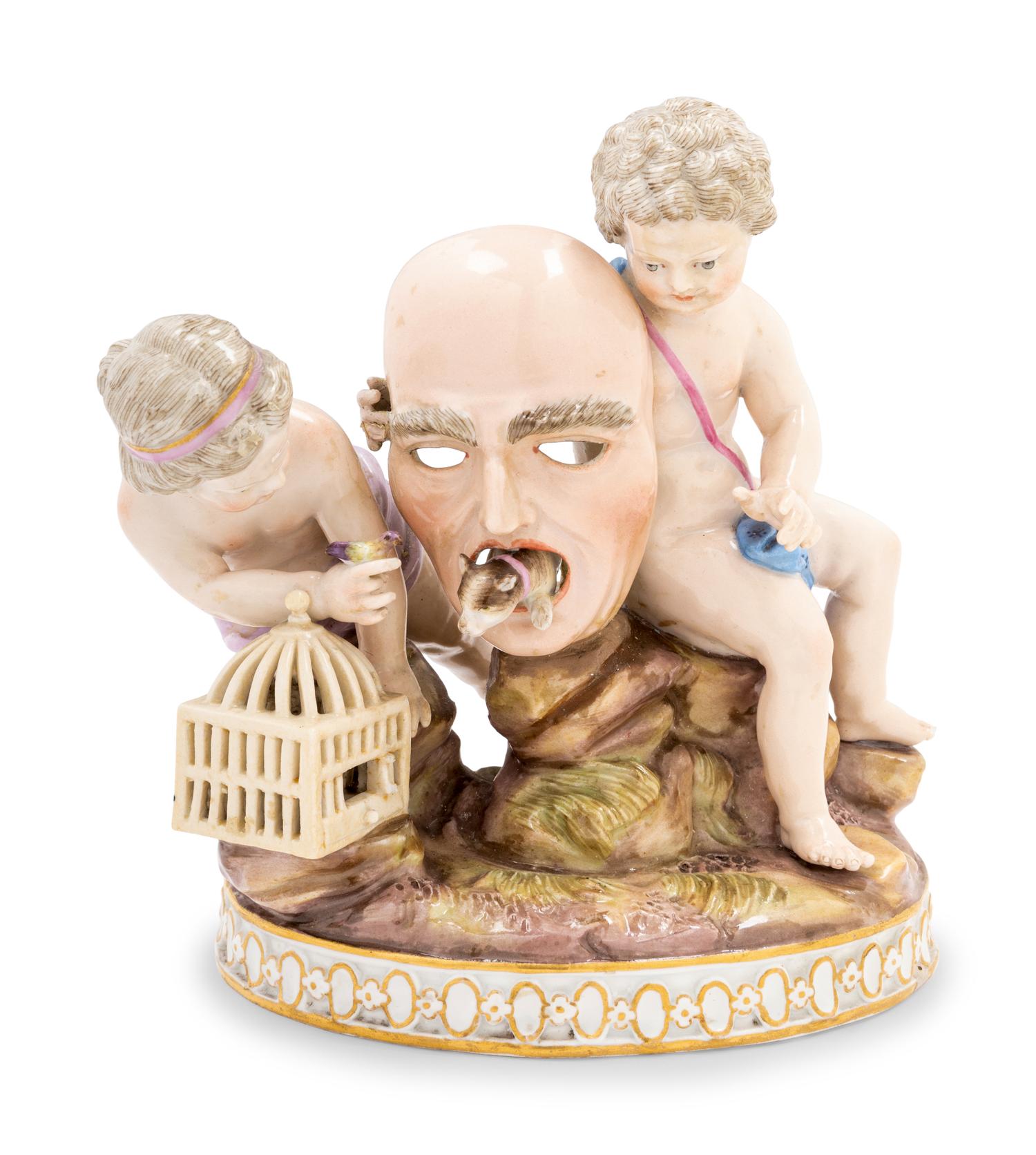 A Meissen Porcelain Group of Two Putti with a Theater Mask, Dog and Birdcage