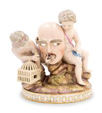 A Meissen Porcelain Group of Two Putti with a Theater Mask, Dog and Birdcage