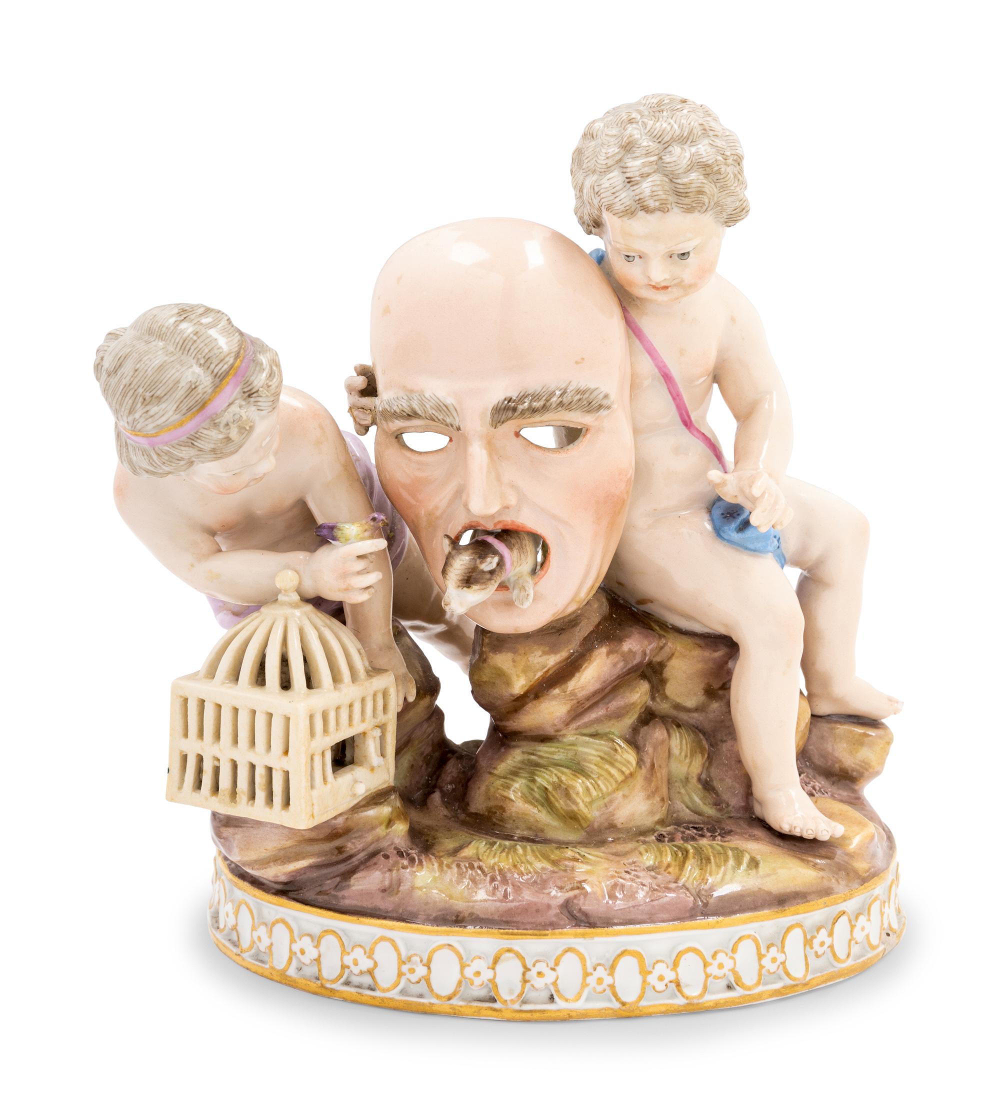 A Meissen Porcelain Group of Two Putti with a Theater Mask, Dog and Birdcage