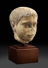 A Roman Marble Head of a Youth Height 8 inches. — CIRCA 2ND CENTURY C.E.