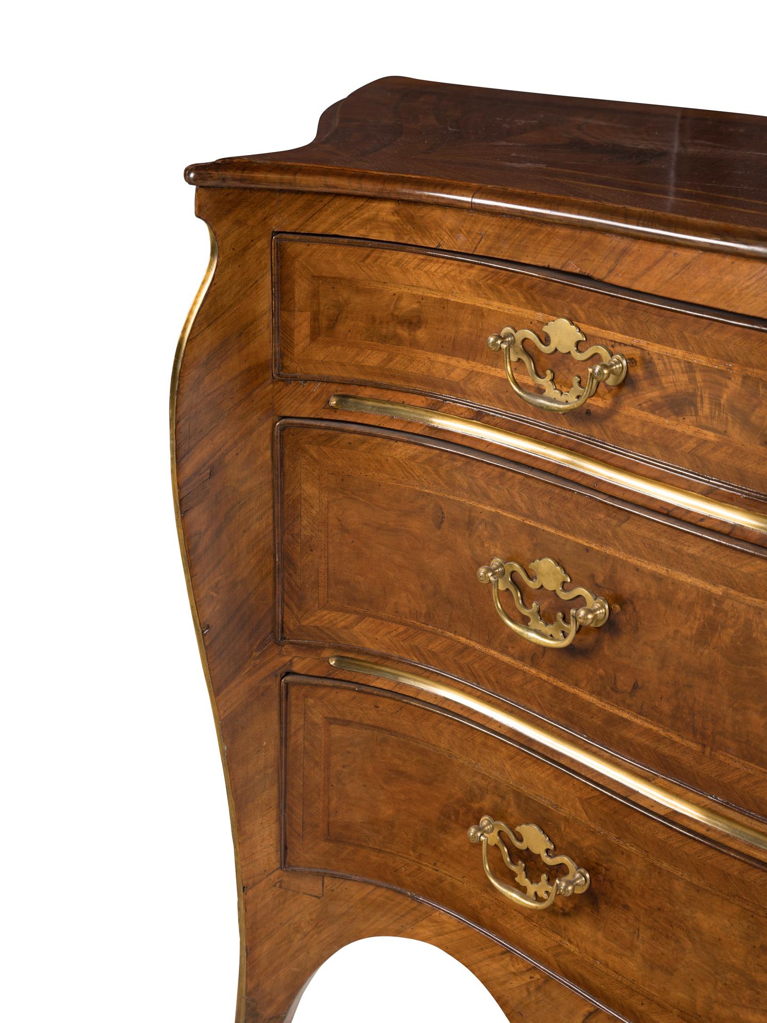 An Italian Gilt Bronze Mounted Serpentine Walnut Commode