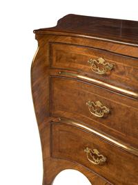 An Italian Gilt Bronze Mounted Serpentine Walnut Commode