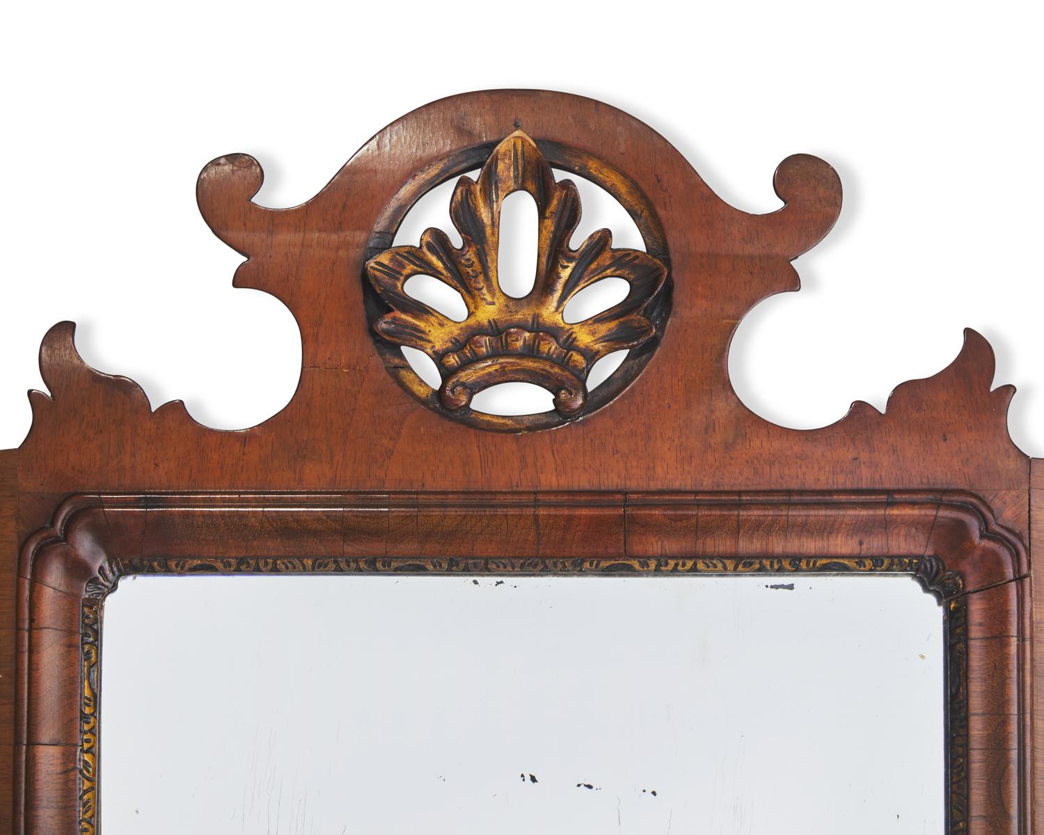 A Chippendale Fret-Carved and Parcel-Gilt and Inlaid Mahogany Mirror