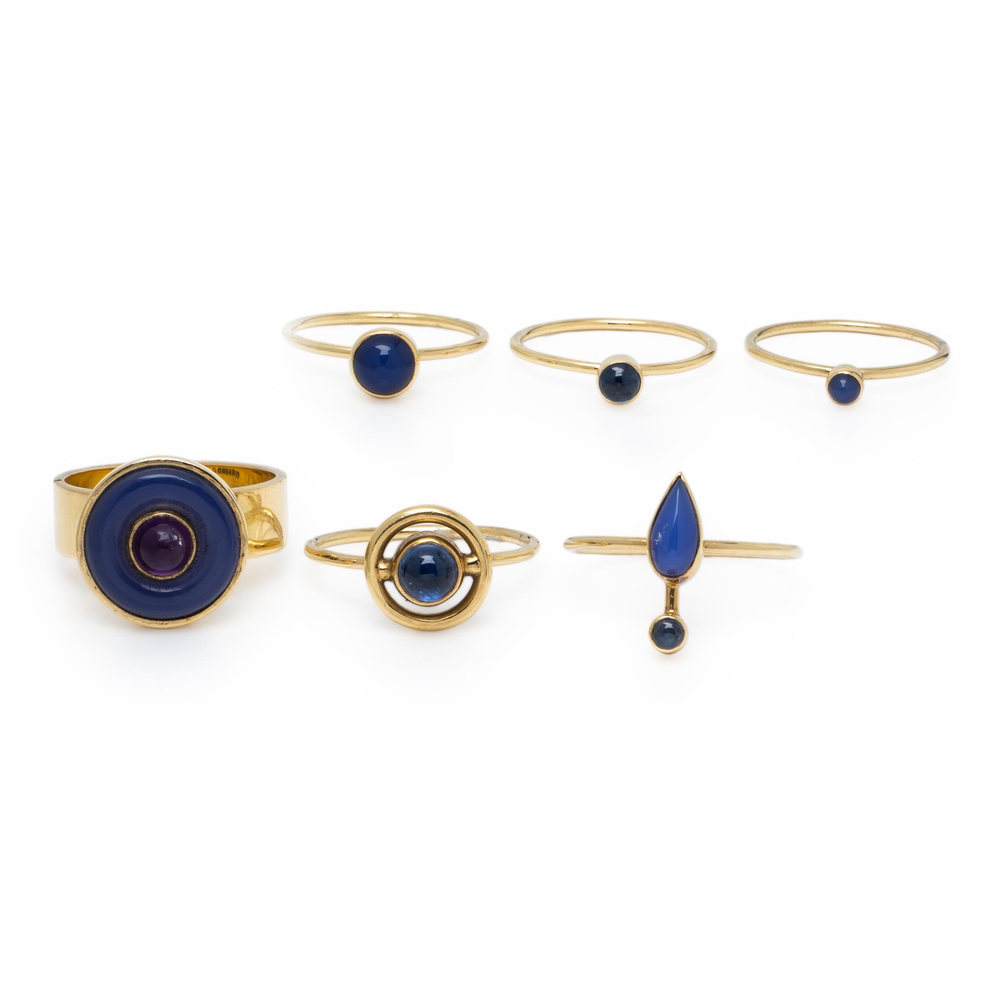 Wendy Ramshaw, Ring Set of Six Yellow Gold and Multigem Stacking Rings on a White Metal and Enamel Ring Stand