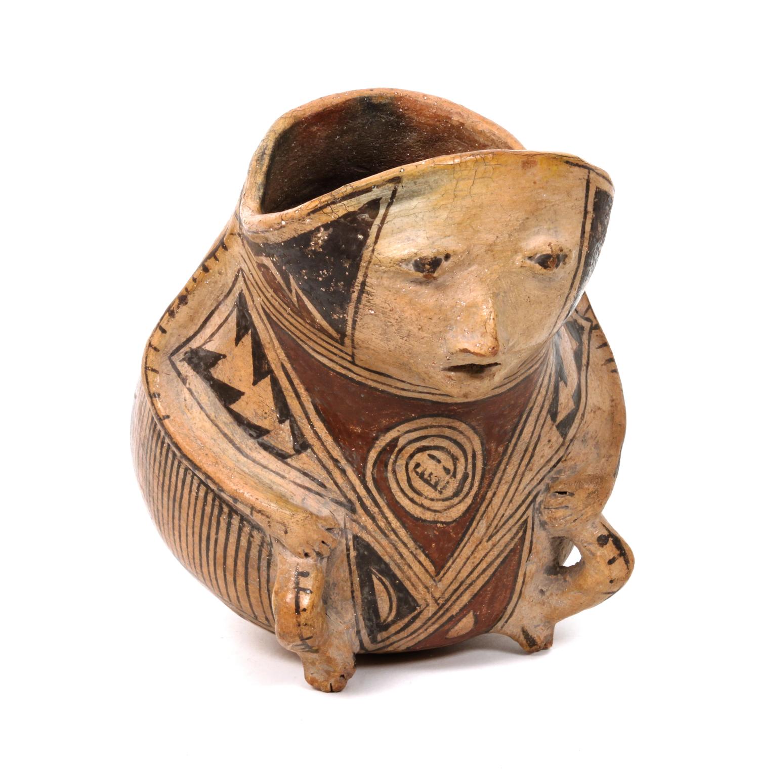 A Casas Grande Polychrome Human Effigy Vessel Height 8 x diameter 5 1/2 inches.