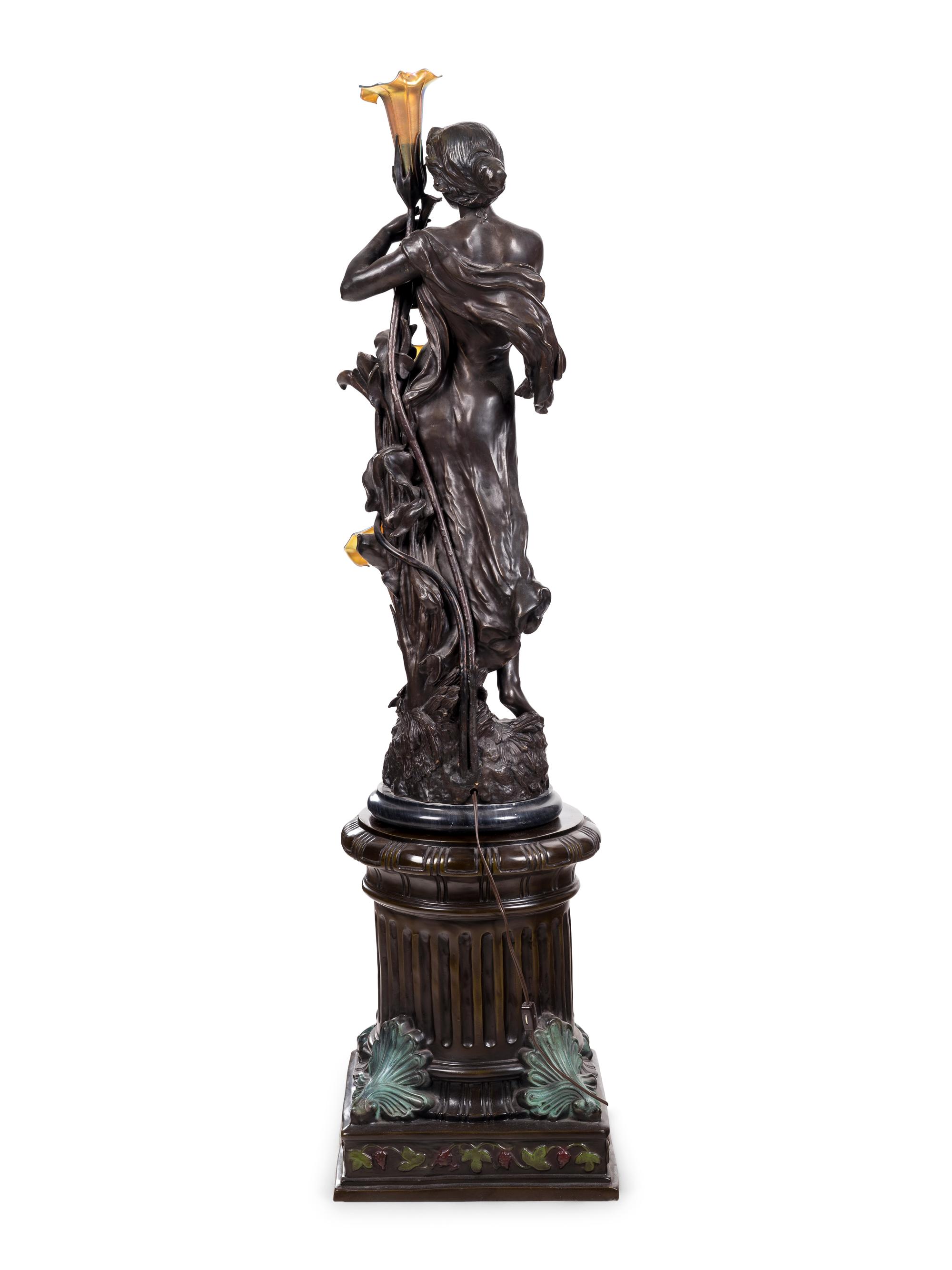 A Patinated Bronze Figural Lamp with Iridescent Glass Shades after Hippolyte François Moreau (French, 1832-1927)