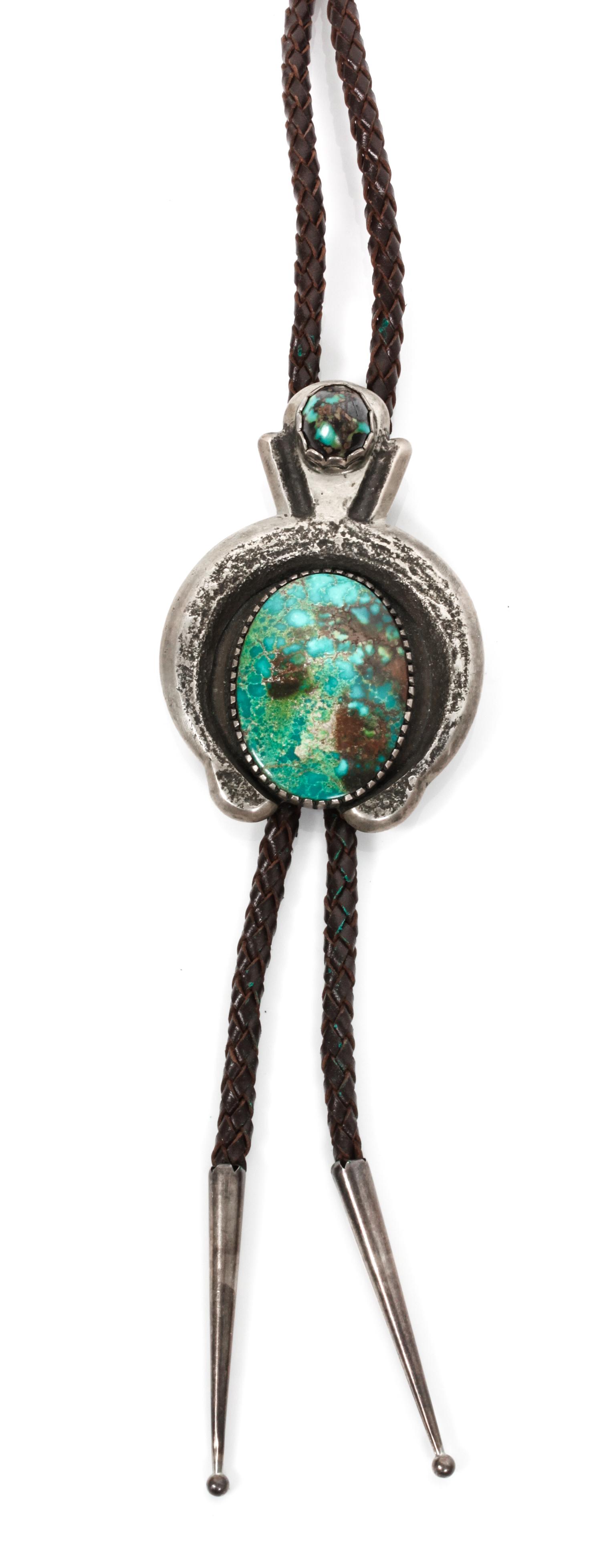 A Navajo Silver and Turquoise Bolo, Chester Kahn Height 3 1/4 x width 2 1/4 inches.