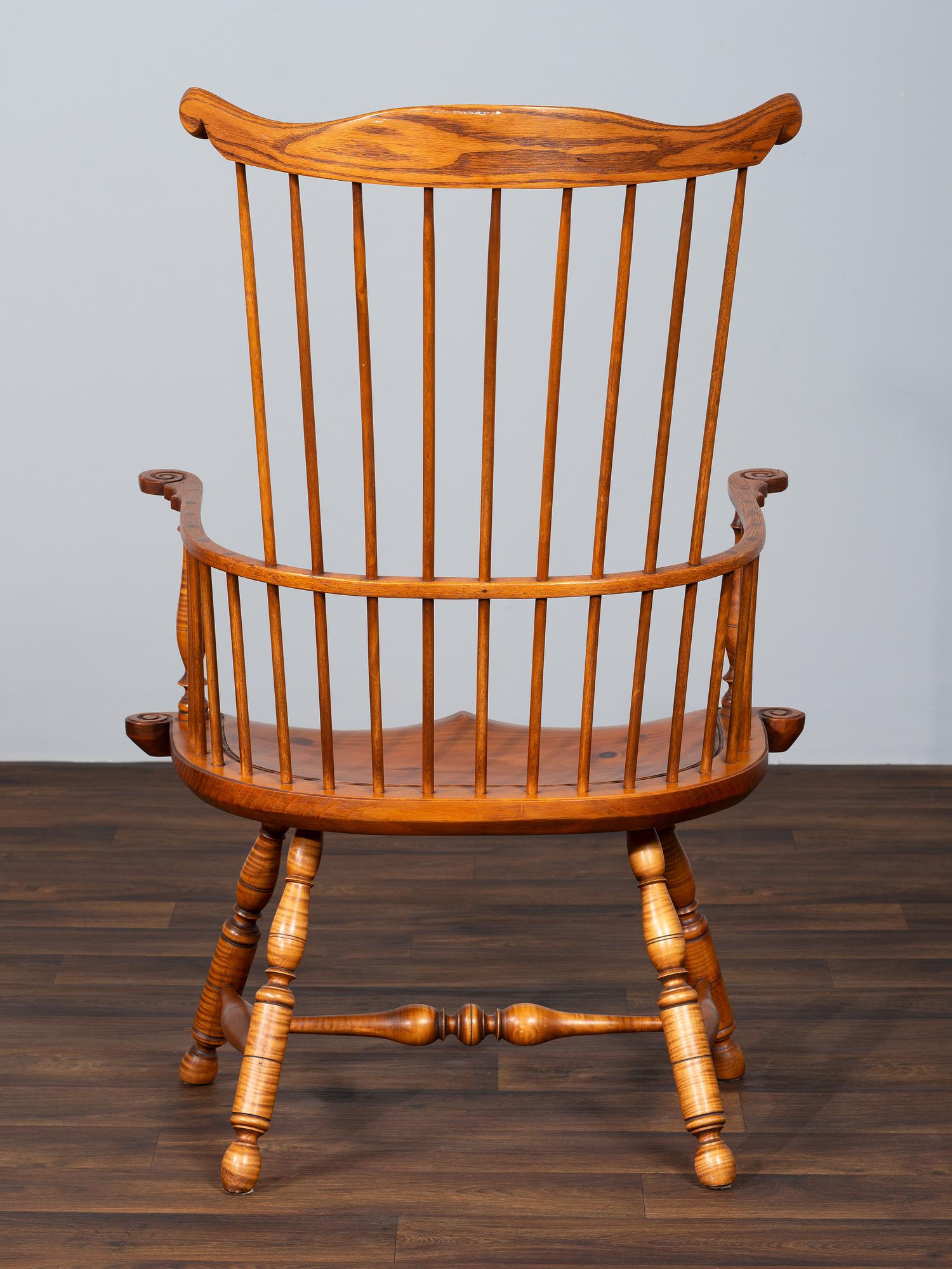 A D.R. Dimes Benchmark Turned and Volute Carved Tiger Maple and Pine Comb-Back Windsor Armchair