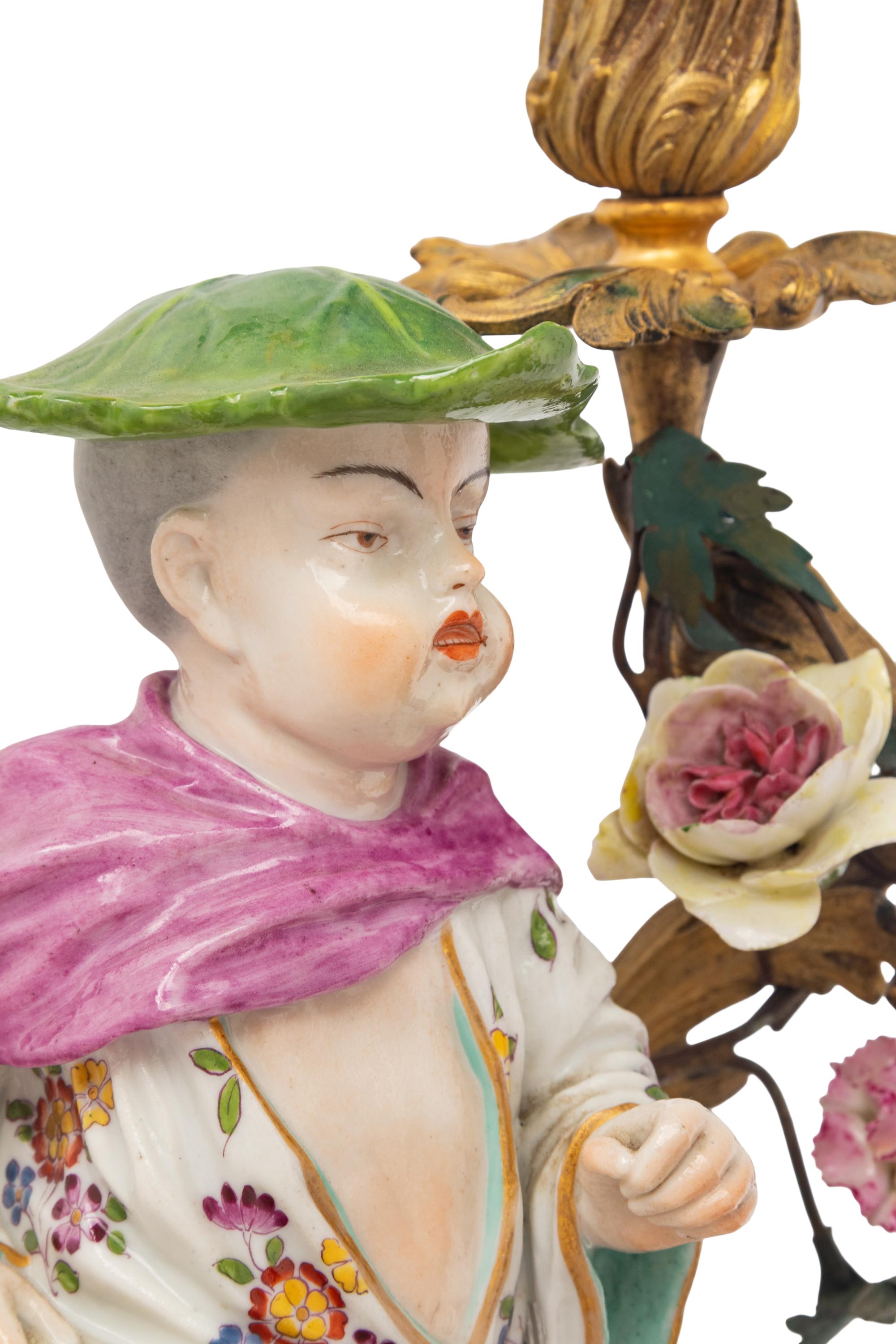 A Pair of French Porcelain, Tôle, and Gilt Bronze Figural Candlesticks
