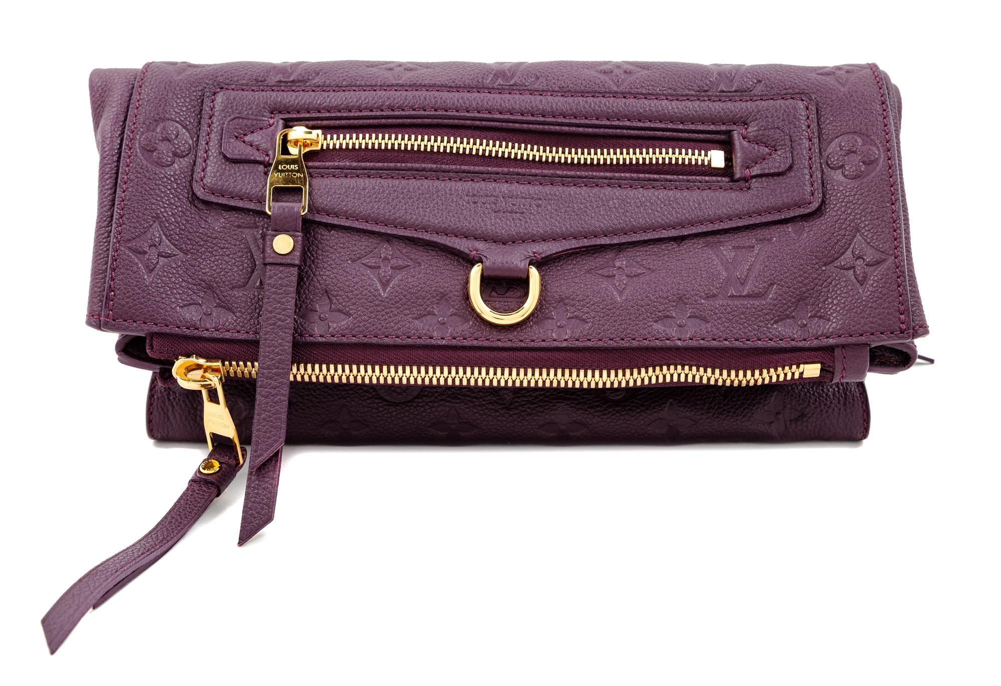 A Louis Vuitton Plum Monogram Empreinte Leather Petillante Clutch, 7" H x 10.75" W x 2.5" D.