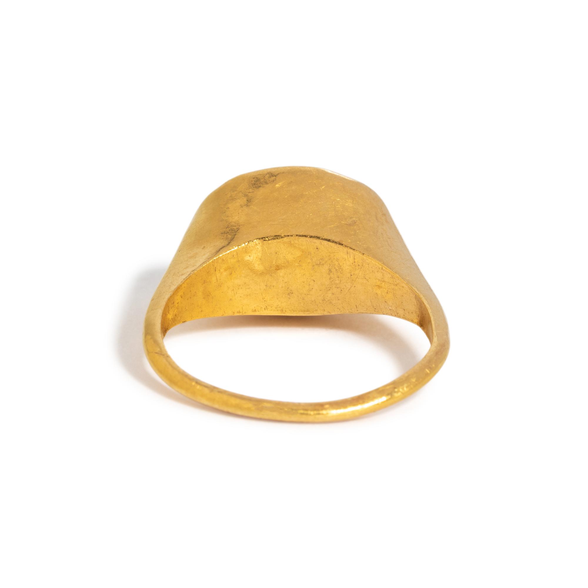 A Roman Gold and Garnet Finger Ring with the Goddess Fortuna Thyche.
