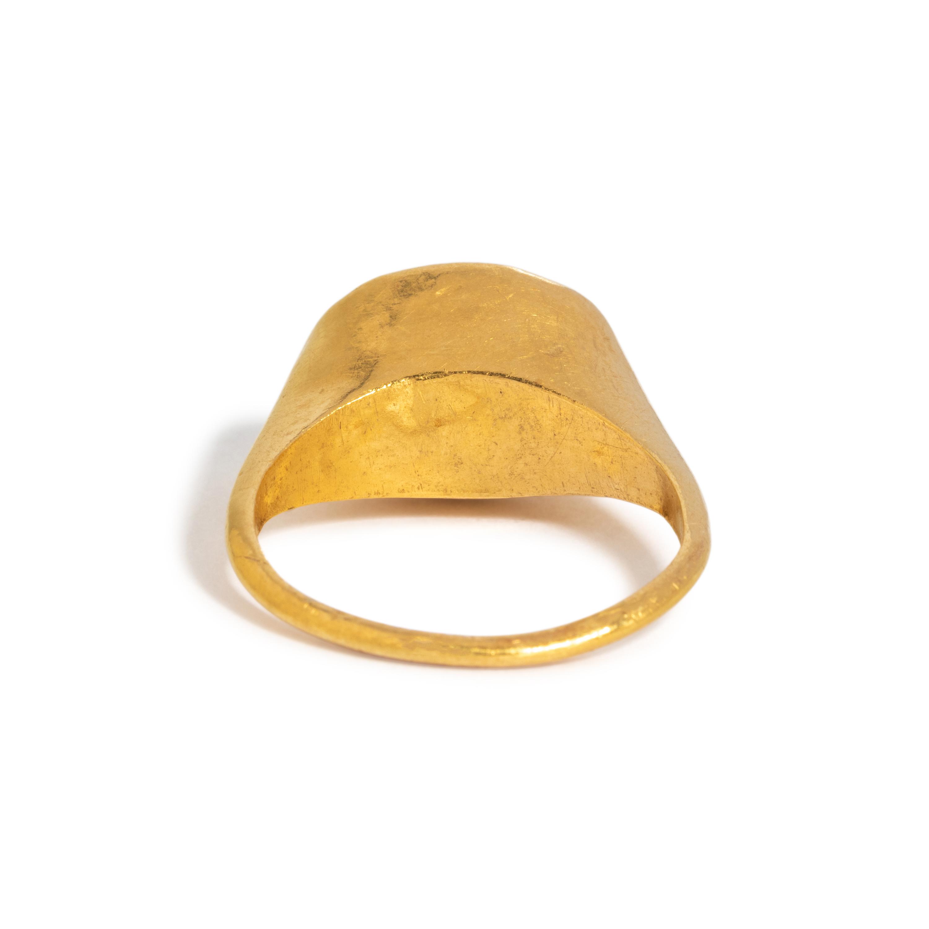 A Roman Gold and Garnet Finger Ring with the Goddess Fortuna Thyche.