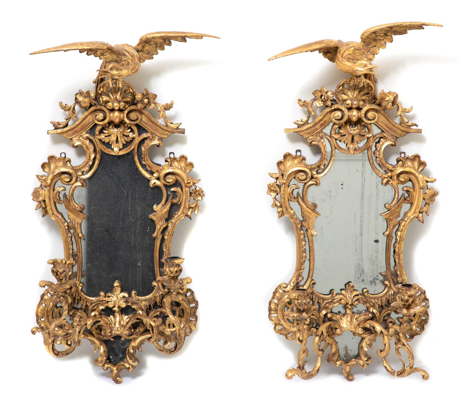 A Pair of George II Style Carved Giltwood Two-Light Mirrored Sconces Height 31 1/2 inches.