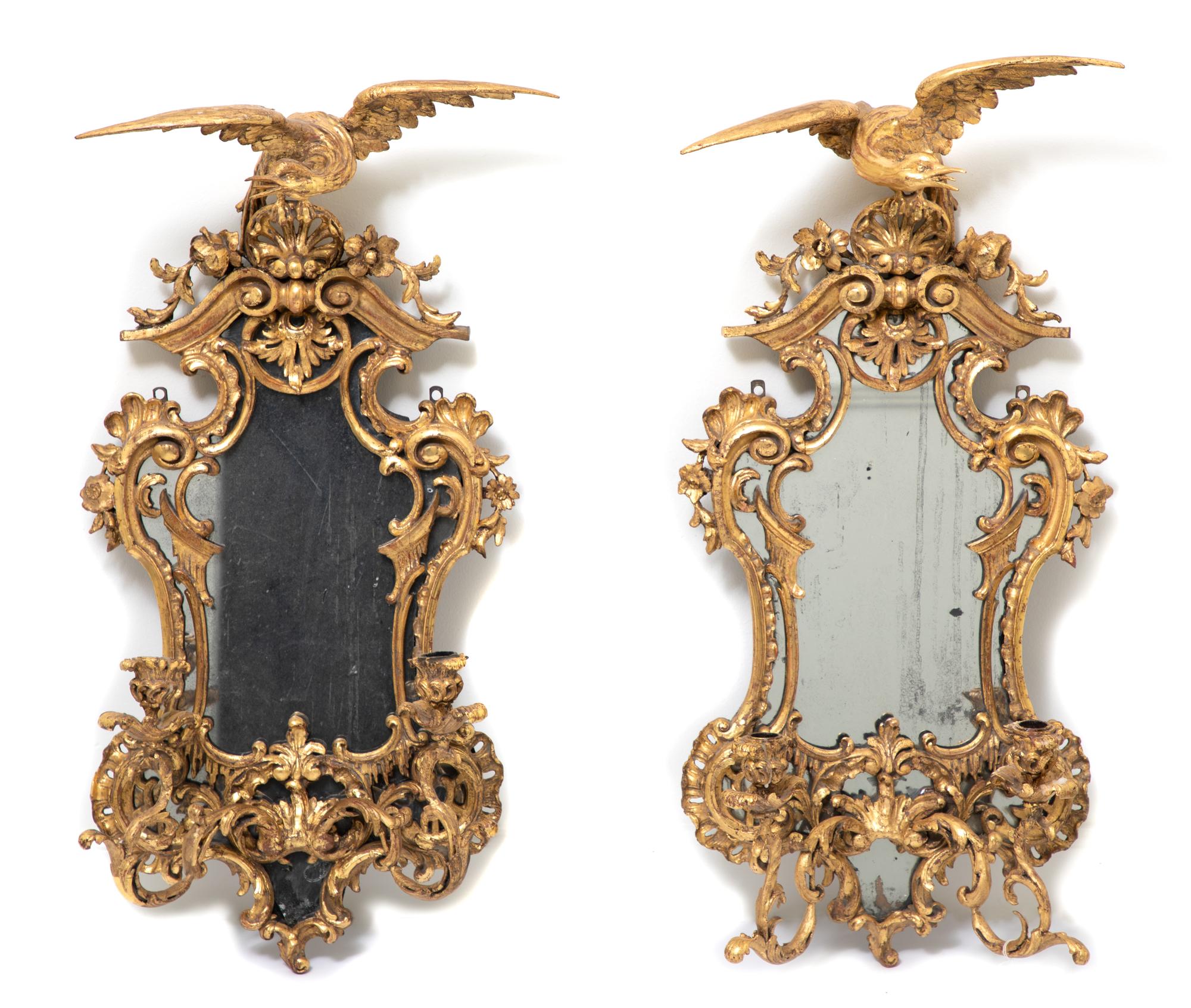 A Pair of George II Style Carved Giltwood Two-Light Mirrored Sconces Height 31 1/2 inches.