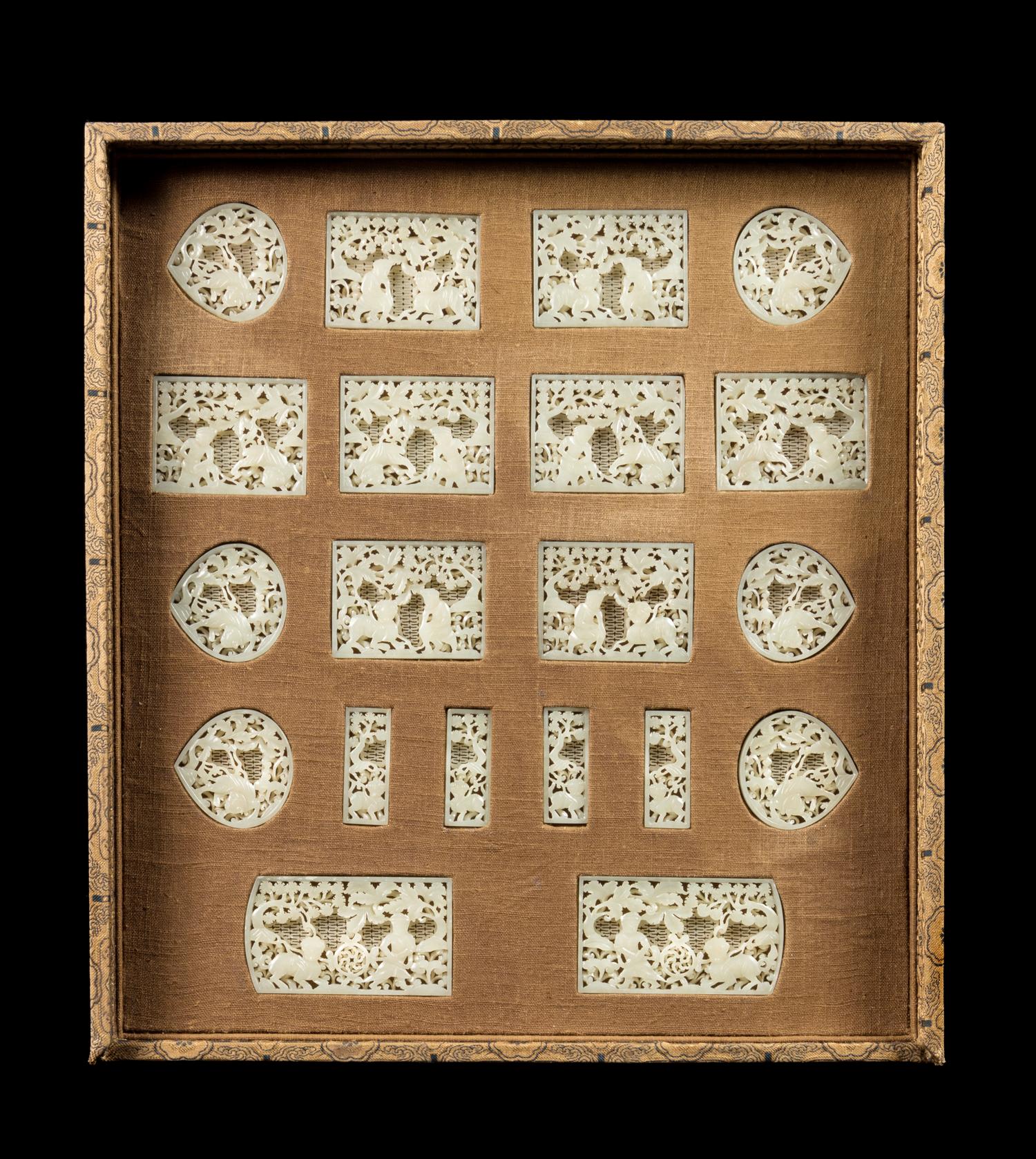 A Set of Twenty Pale-Celadon Jade Belt Ornaments Length of largest 2 inches.