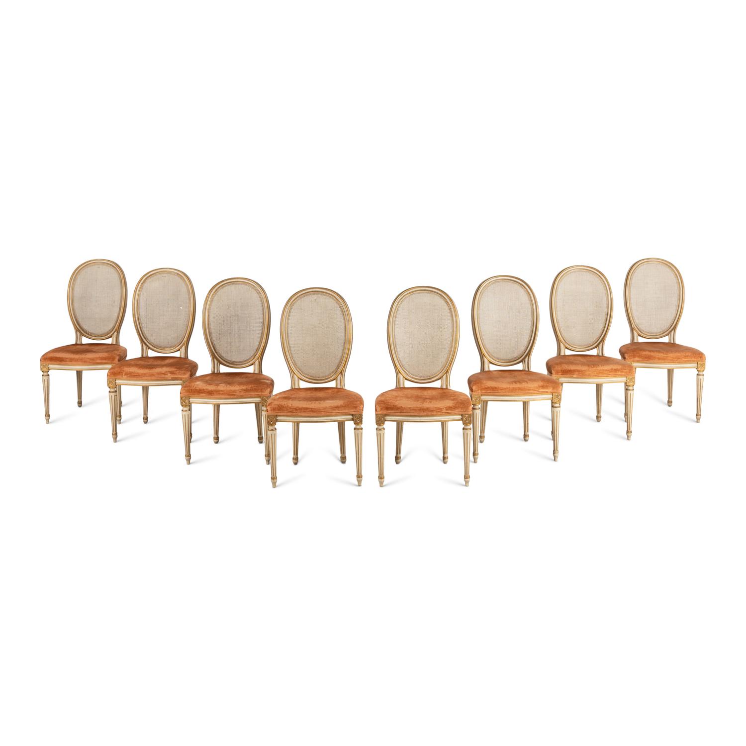 A Set of Eight Louis XVI Style Crème-Painted and Parcel Gilt Dining Chairs