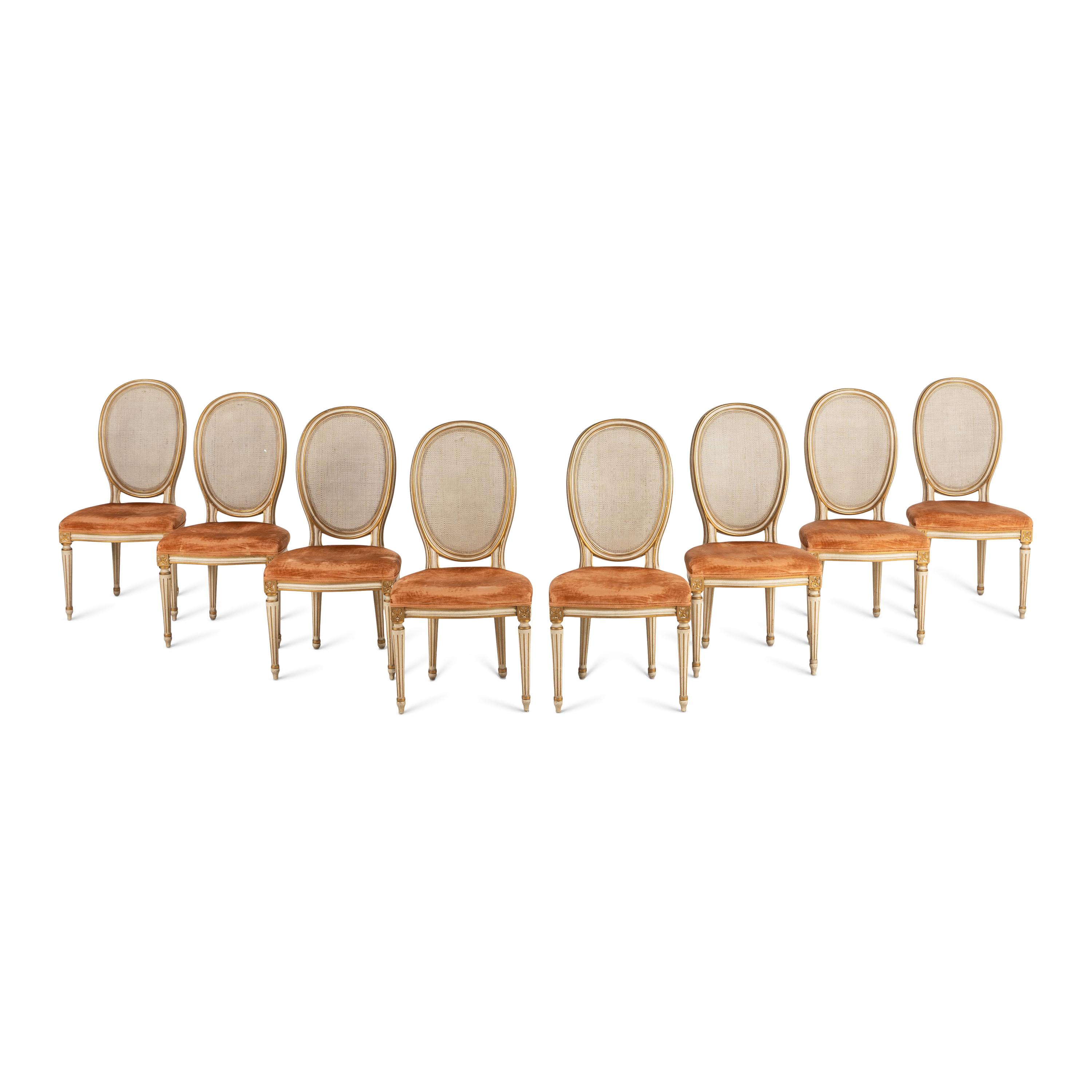 A Set of Eight Louis XVI Style Crème-Painted and Parcel Gilt Dining Chairs