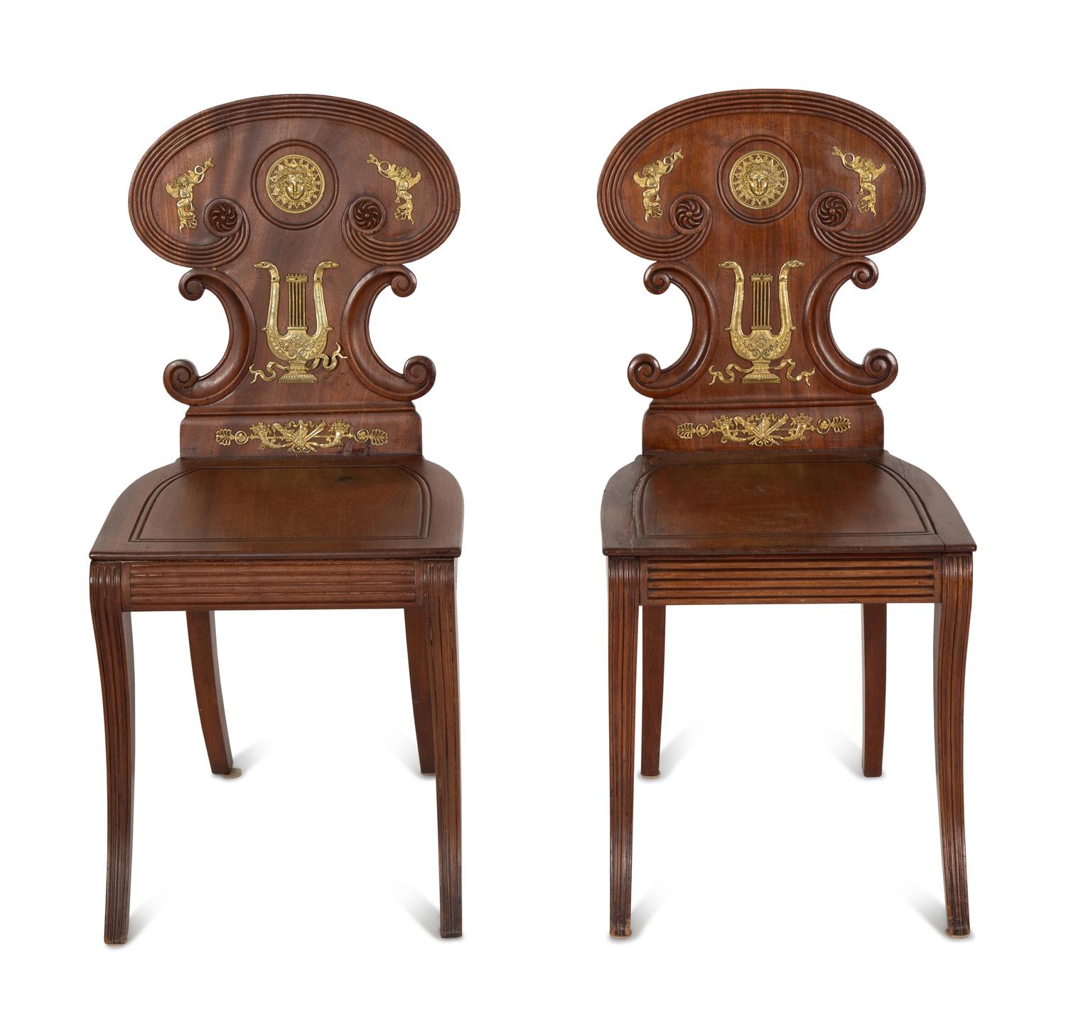 A Pair of French Empire Style Gilt Metal Mounted Mahogany Hall Chairs