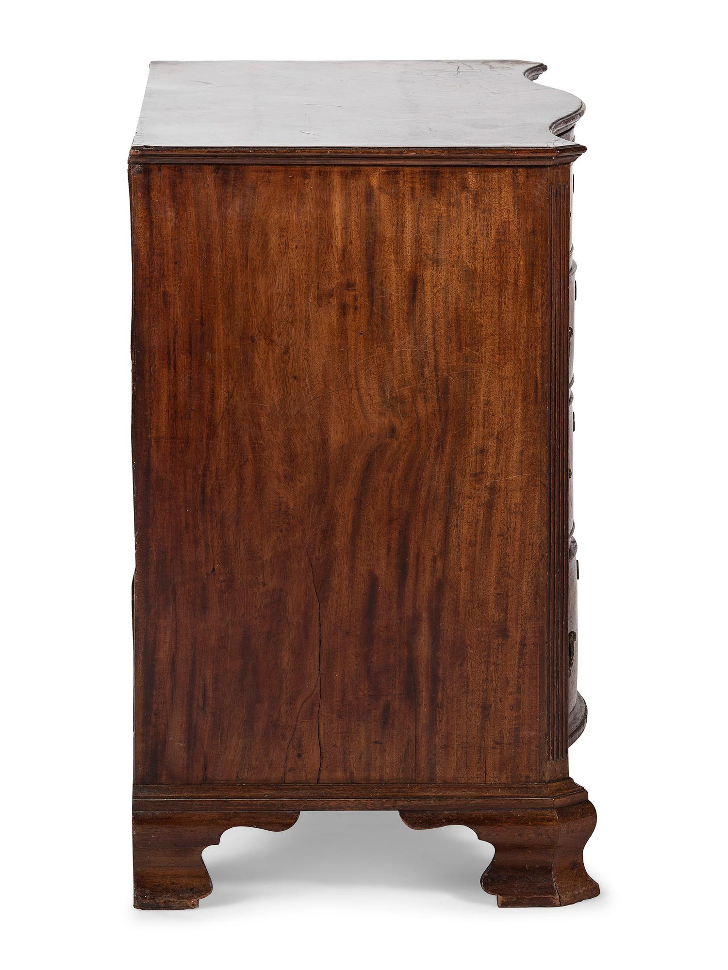 A George III Figured Mahogany Serpentine Front Bachelor's Chest