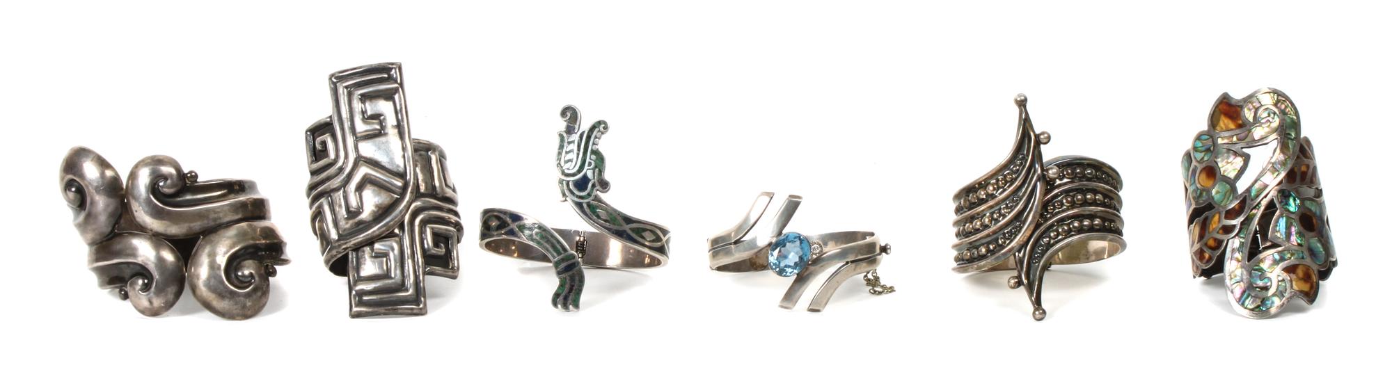 Six Mexican Silver Hinged Cuff Bracelets. Length of largest 7 1/4 x width 3 inches.