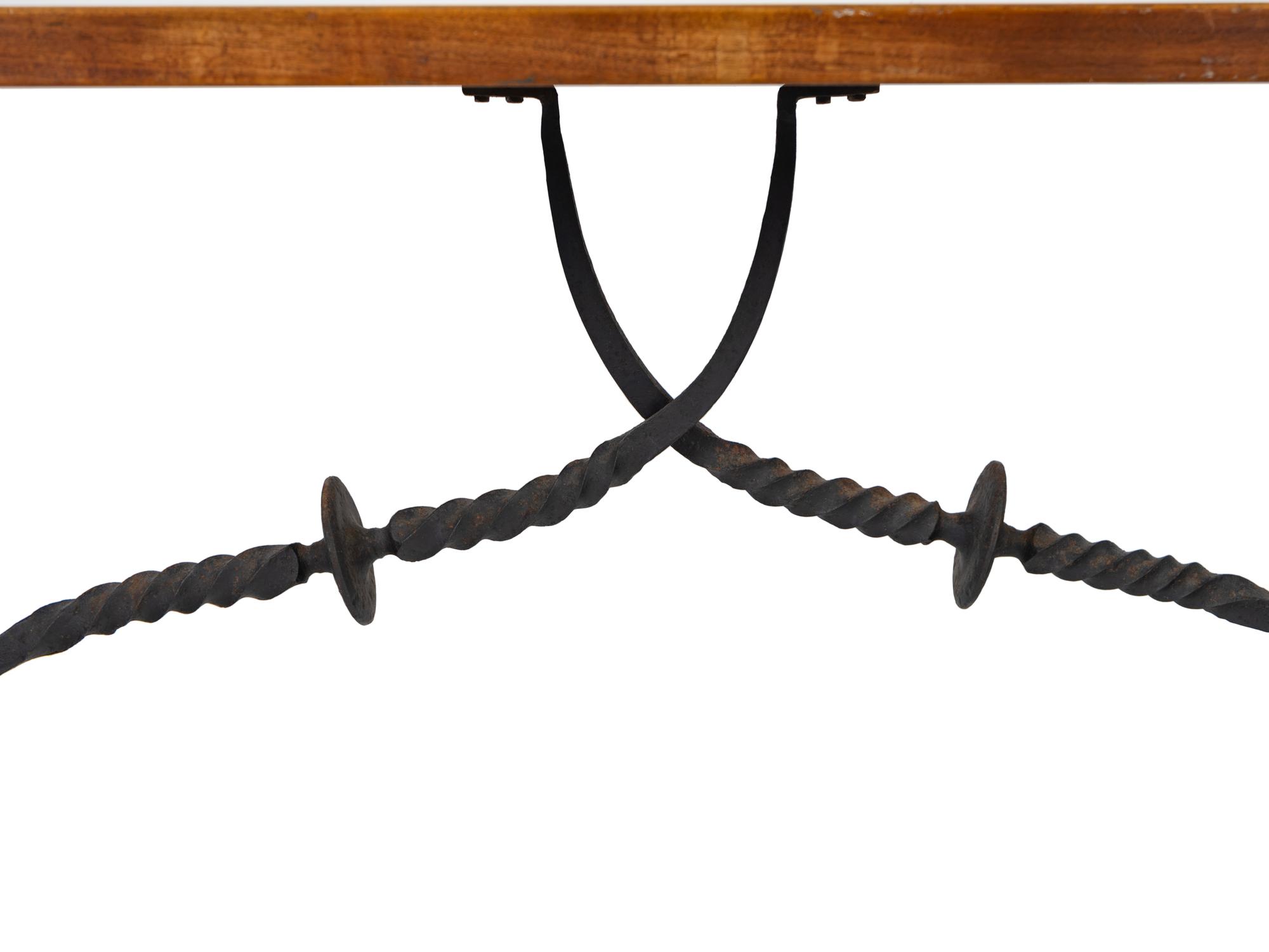 A Spanish Colonial Style Walnut Trestle Table with Wrought Iron Stretcher — 19TH CENTURY