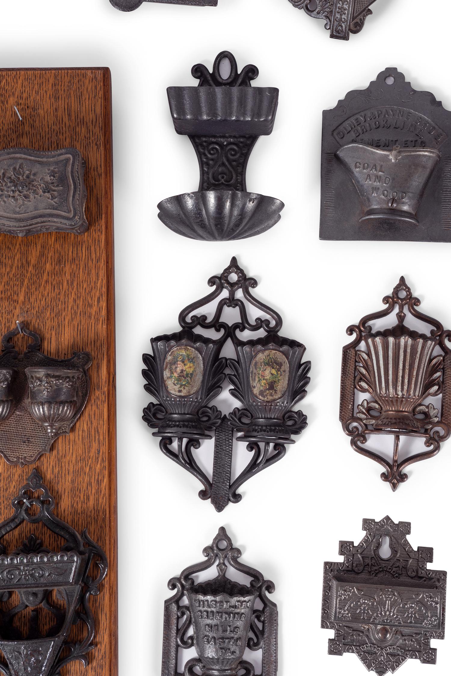 A Group of Cast Iron Hanging Match Holders