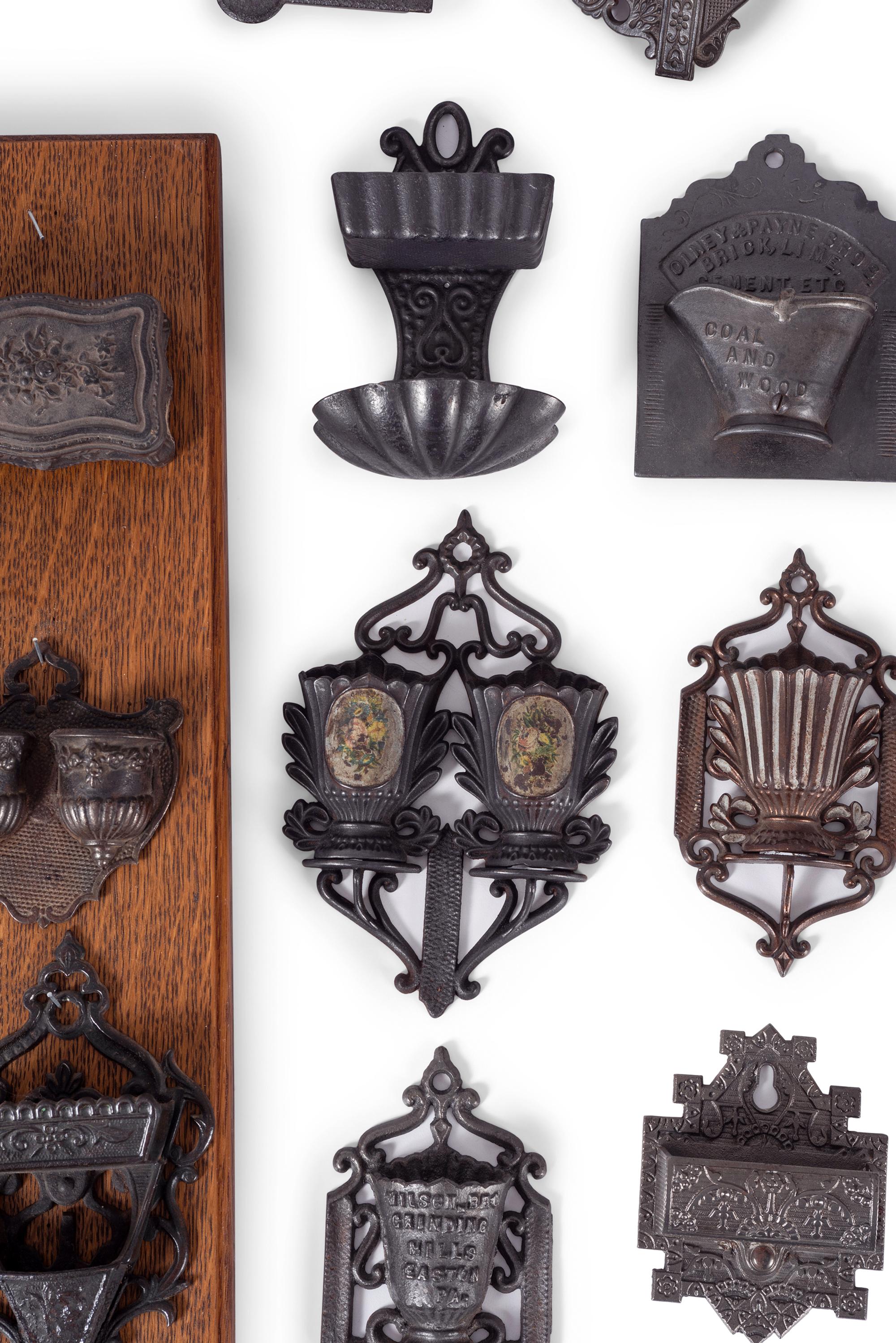 A Group of Cast Iron Hanging Match Holders