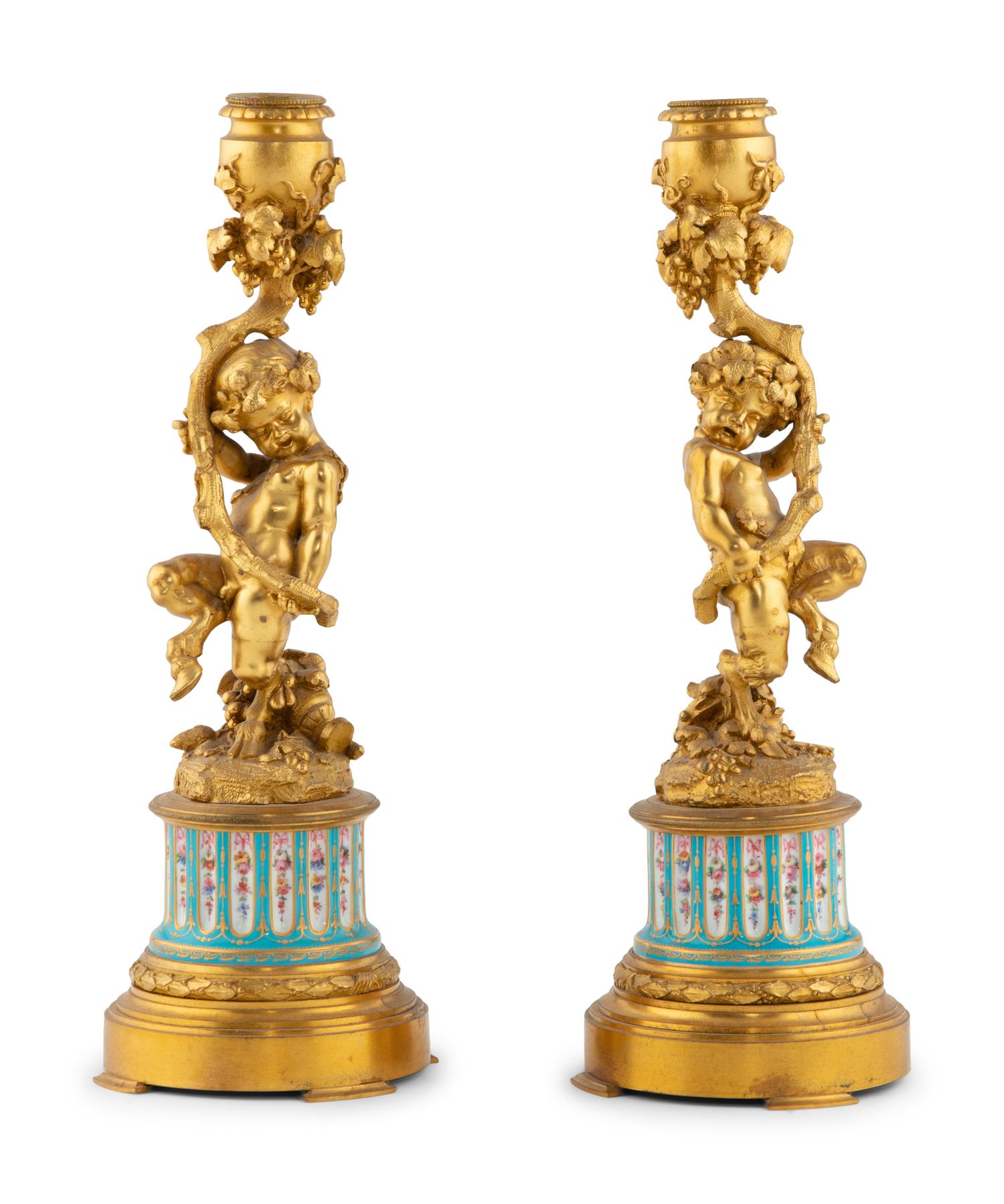 A Pair of French Gilt Bronze and Bourdin Porcelain Figural Candlesticks
