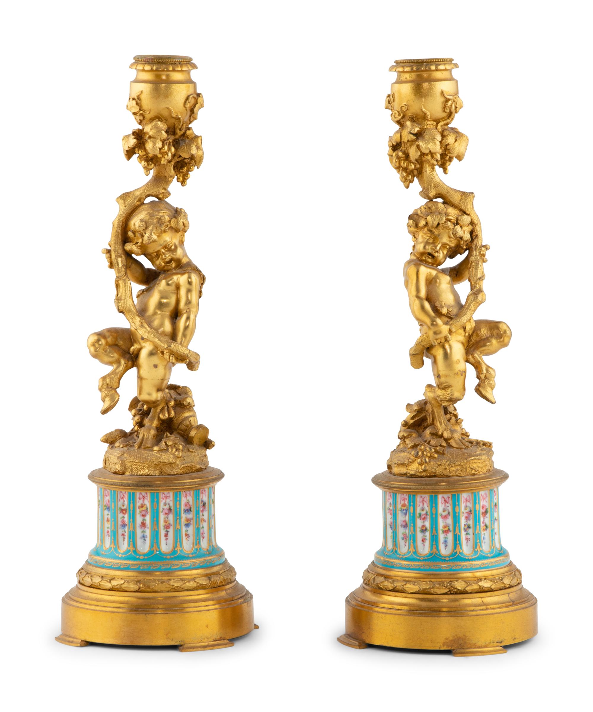 A Pair of French Gilt Bronze and Bourdin Porcelain Figural Candlesticks