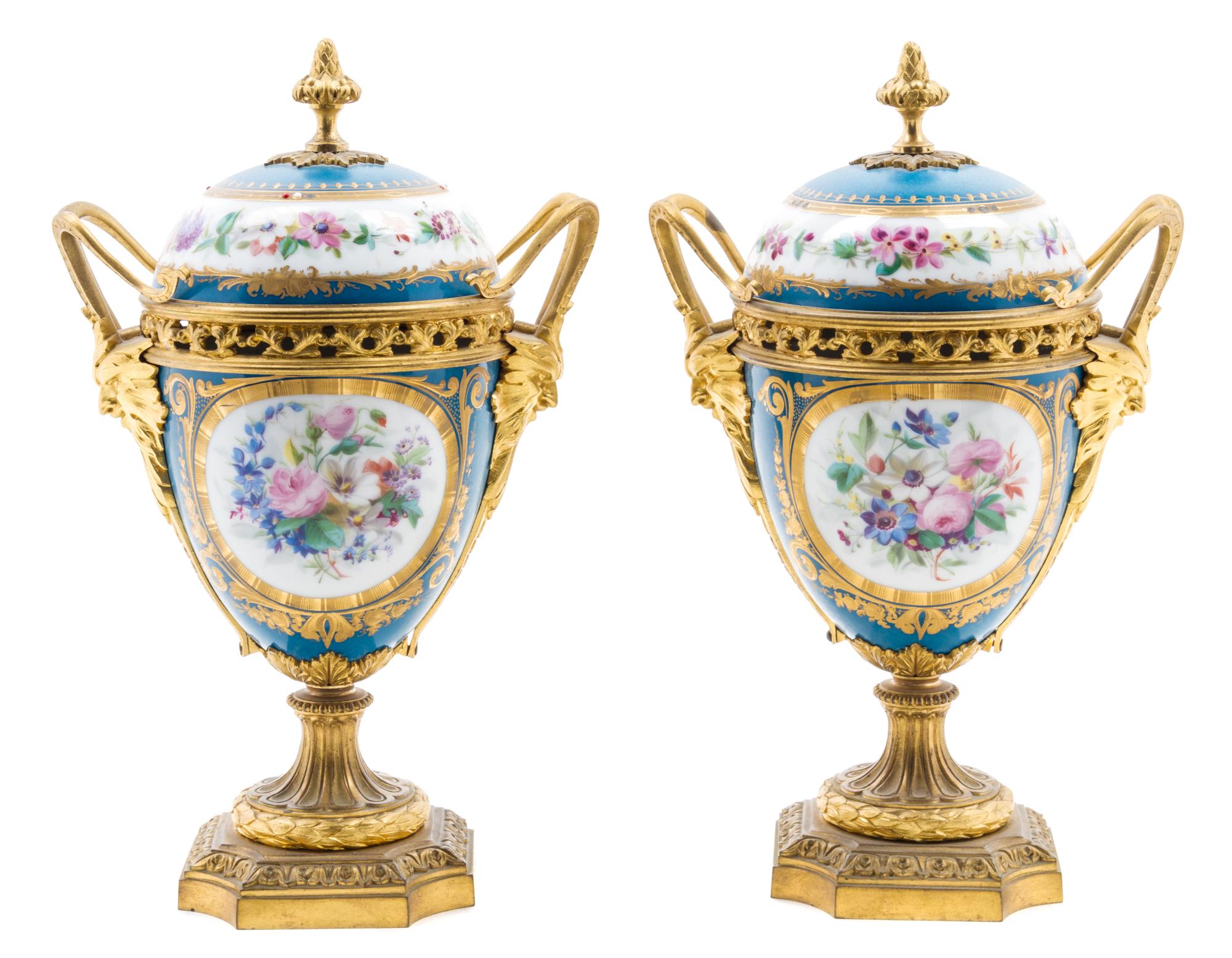 A Pair of Sevres Style Gilt Bronze Mounted Porcelain Urns Height 11 inches. — 19TH/20TH CENTURY