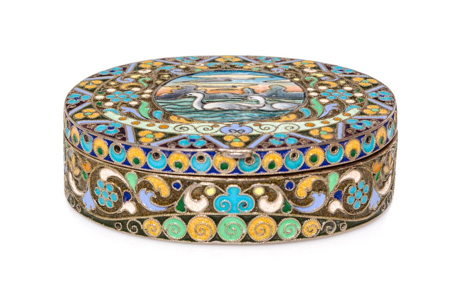 A Russian Enameled Gilt-Silver Box, possibly Bernhard Hinds, Moscow, 1908-1926, of oval form, the lid centered with two swans within a