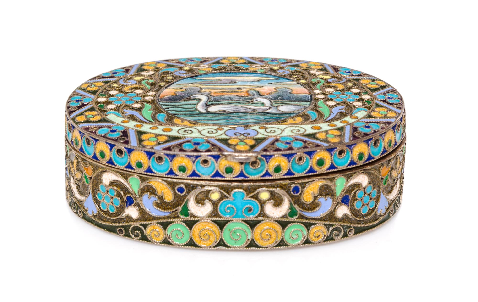 A Russian Enameled Gilt-Silver Box, possibly Bernhard Hinds, Moscow, 1908-1926, of oval form, the lid centered with two swans within a