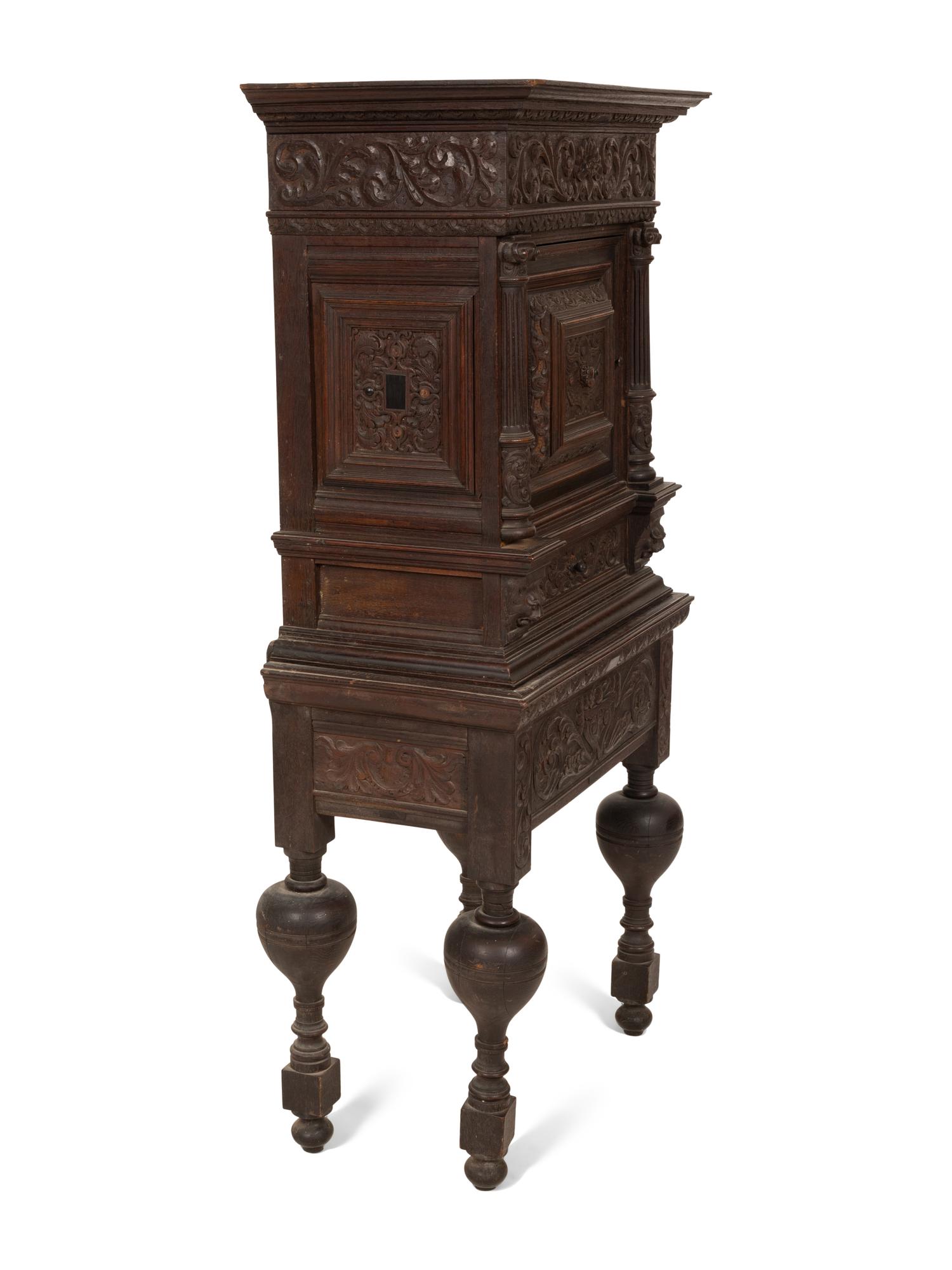 A Pair of Continental Carved Oak Cabinets on Stands