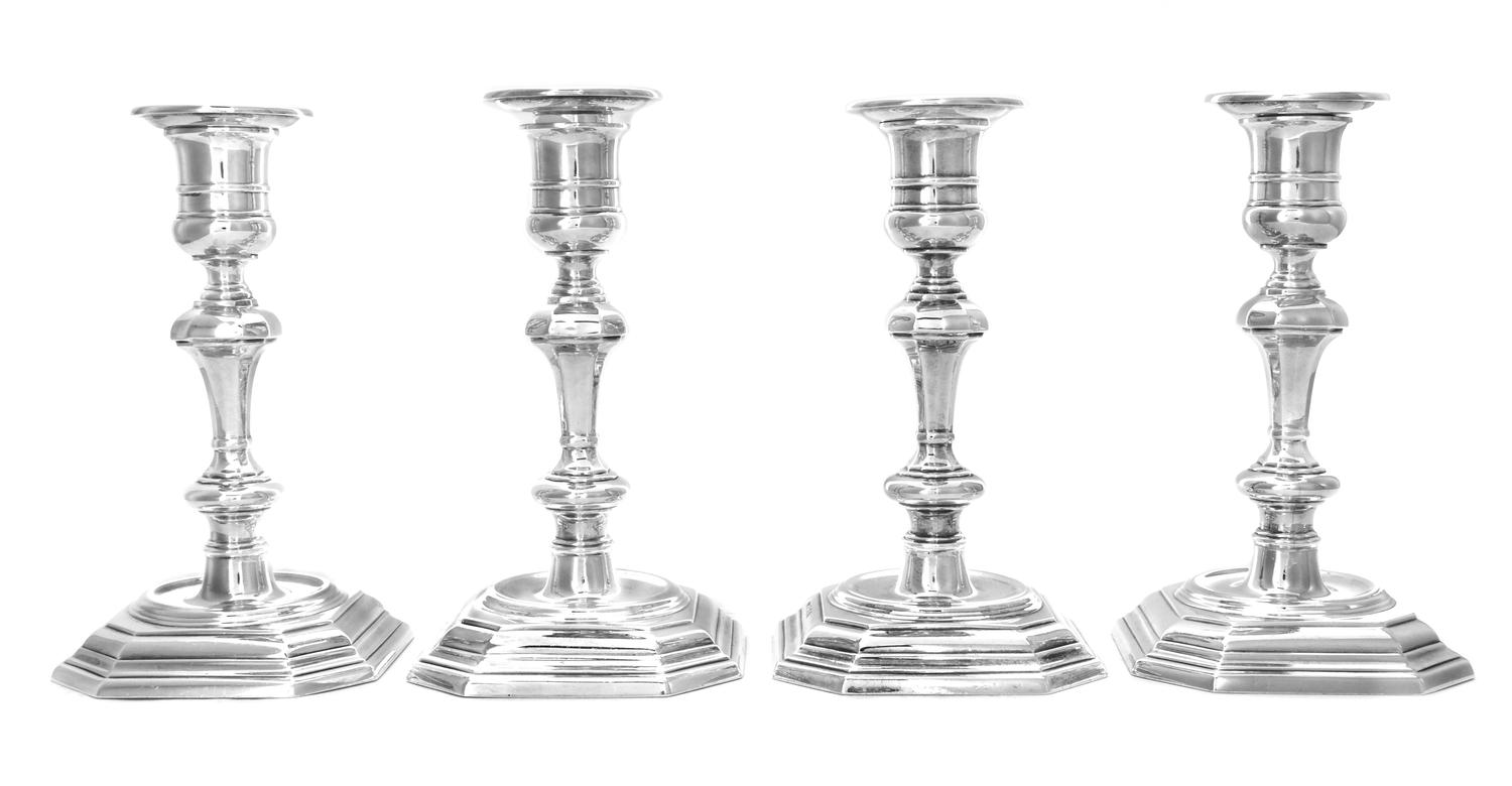 A Set of Four English Silver Candlesticks, Walter H. Wilson Ltd., London, 1955, each having a banded candle cup above the knopped stem,