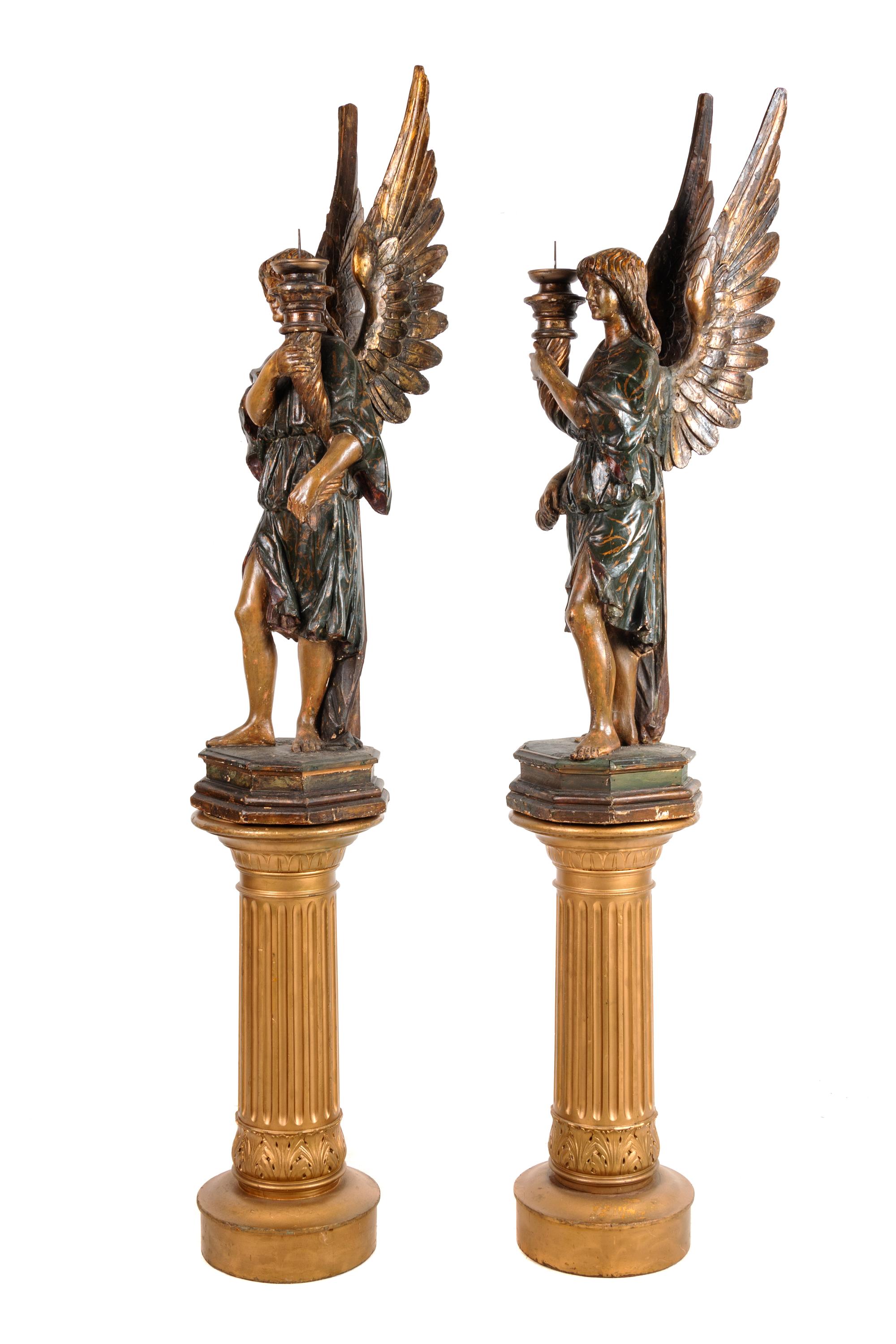 A Pair of Continental Carved and Painted Figural Prickets with Associated Pedestals