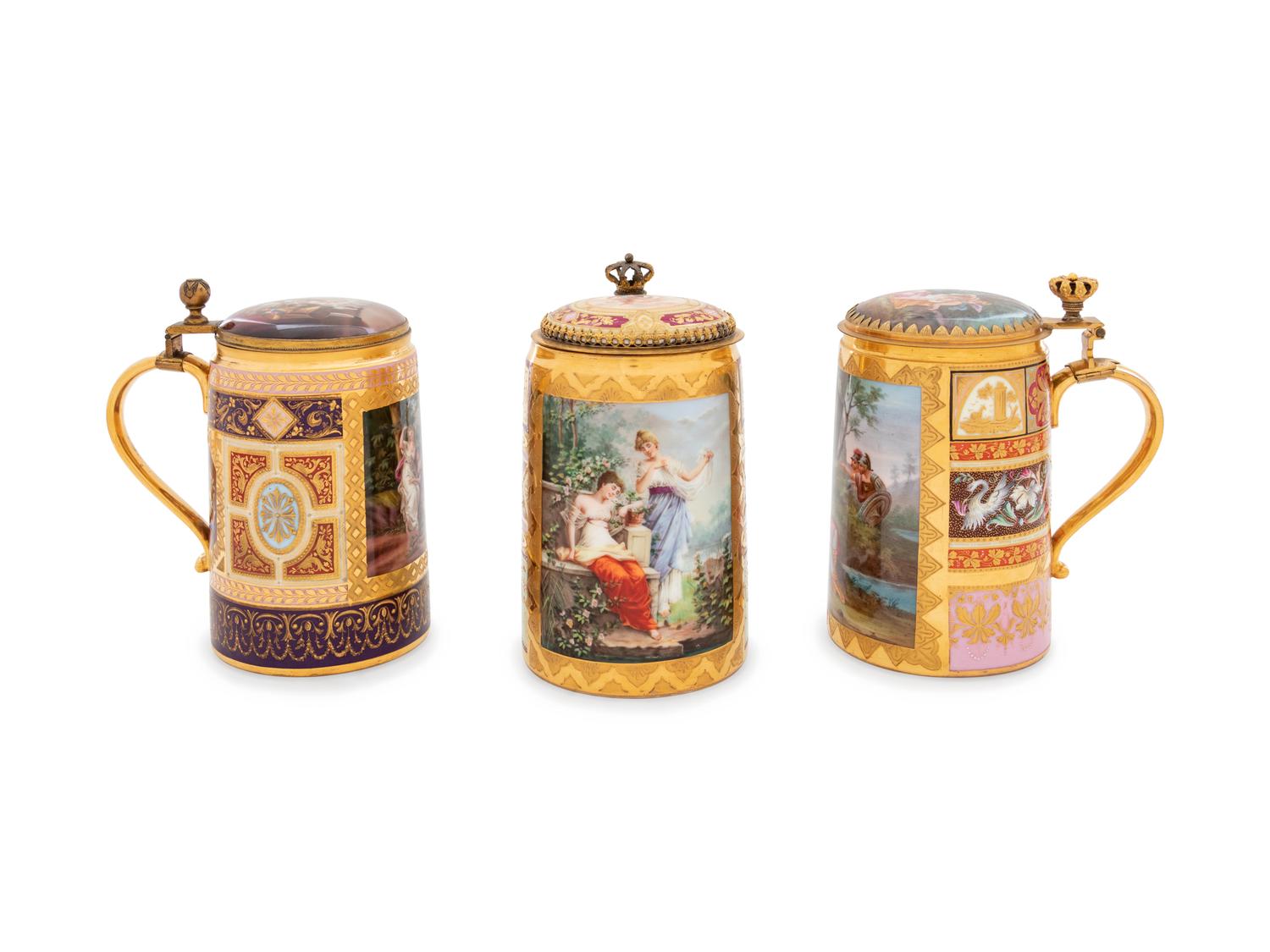 Three Vienna Painted and Parcel Gilt Porcelain Tankards