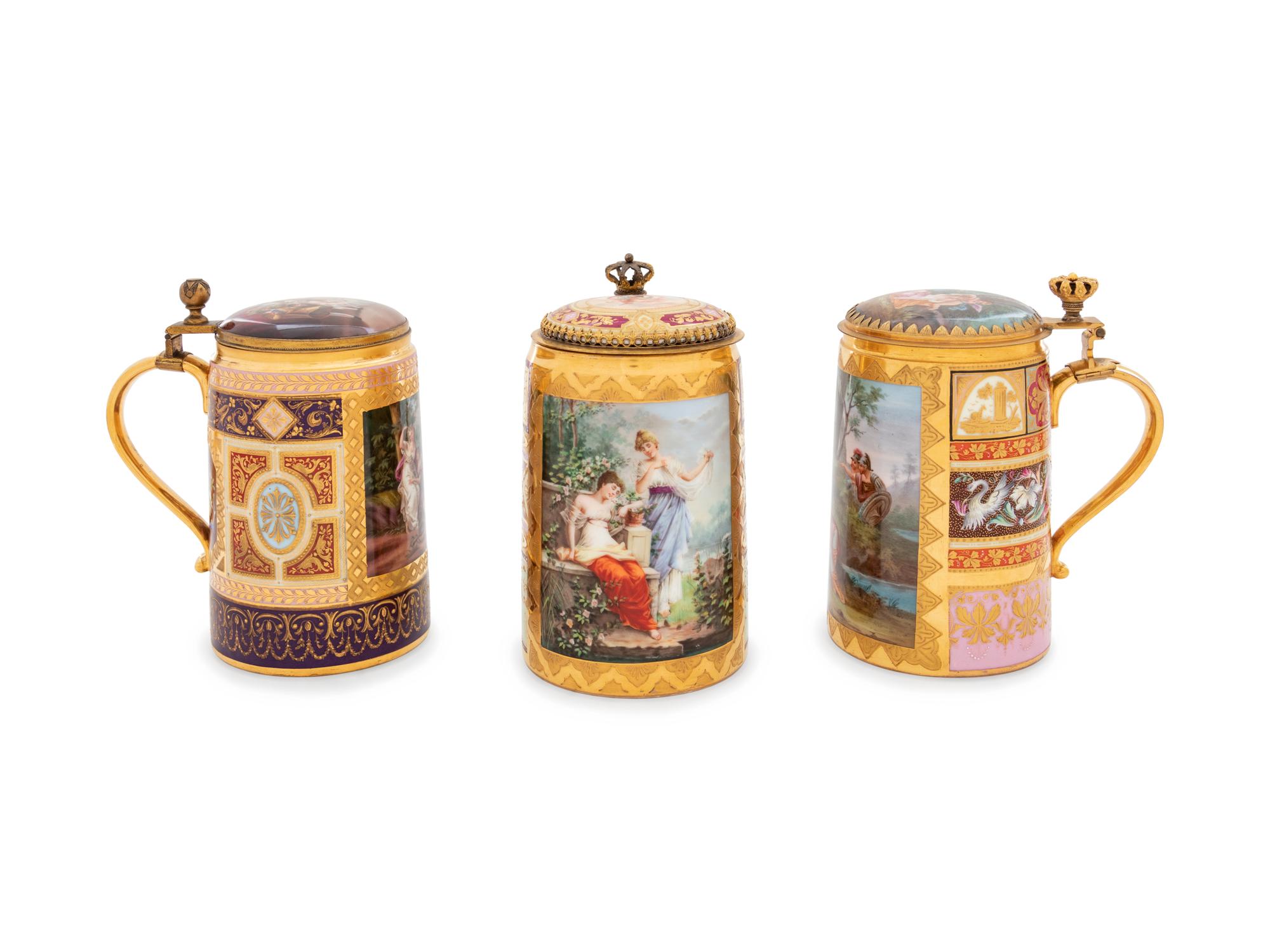 Three Vienna Painted and Parcel Gilt Porcelain Tankards