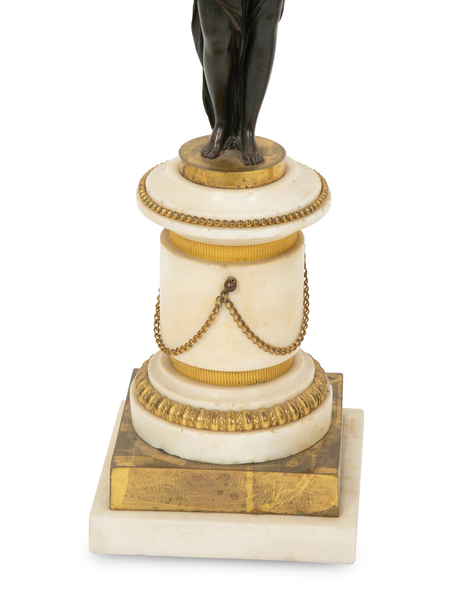 A Pair of French Patinated and Gilt Bronze Figural Three-Light Candelabra