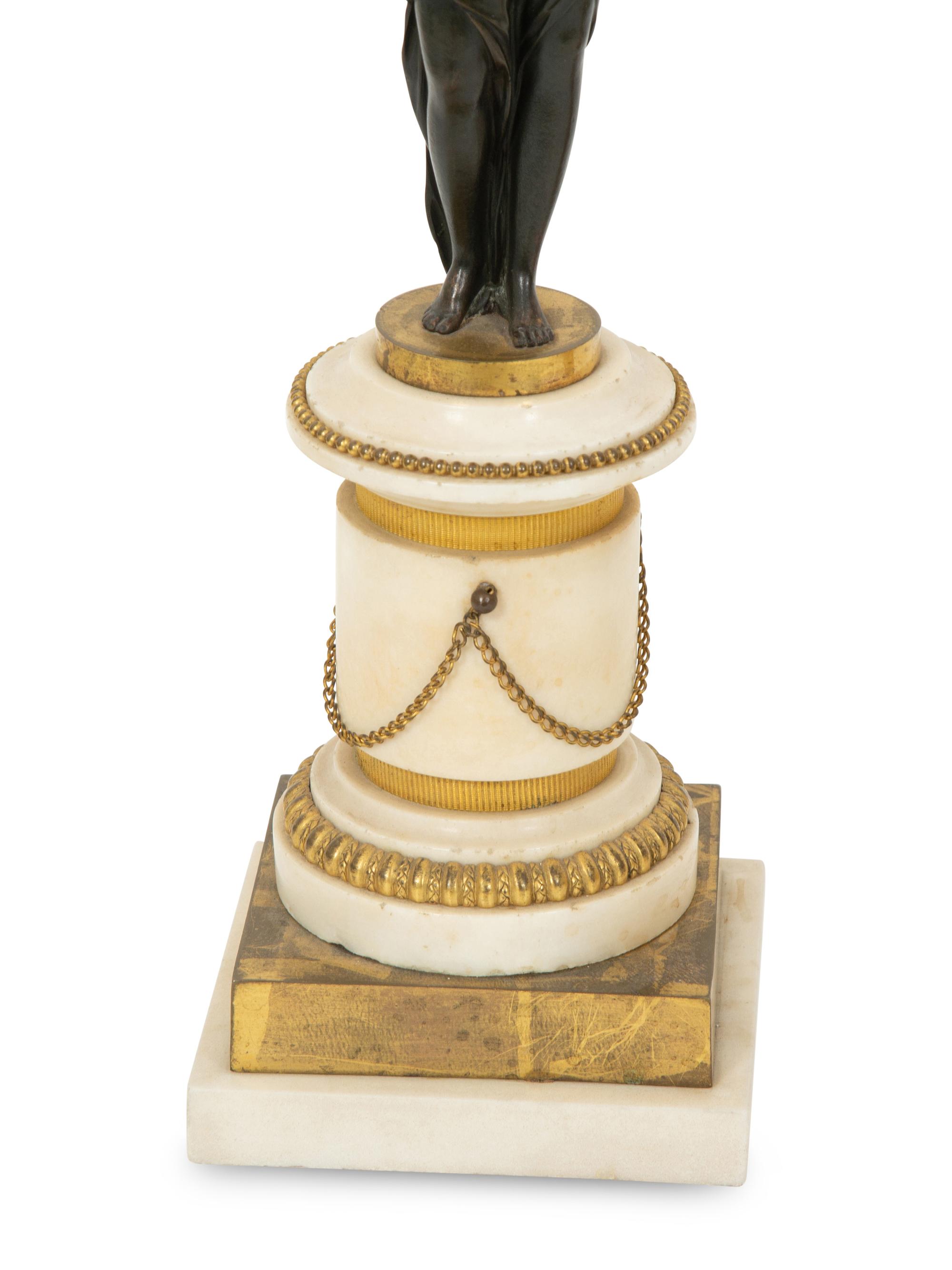 A Pair of French Patinated and Gilt Bronze Figural Three-Light Candelabra
