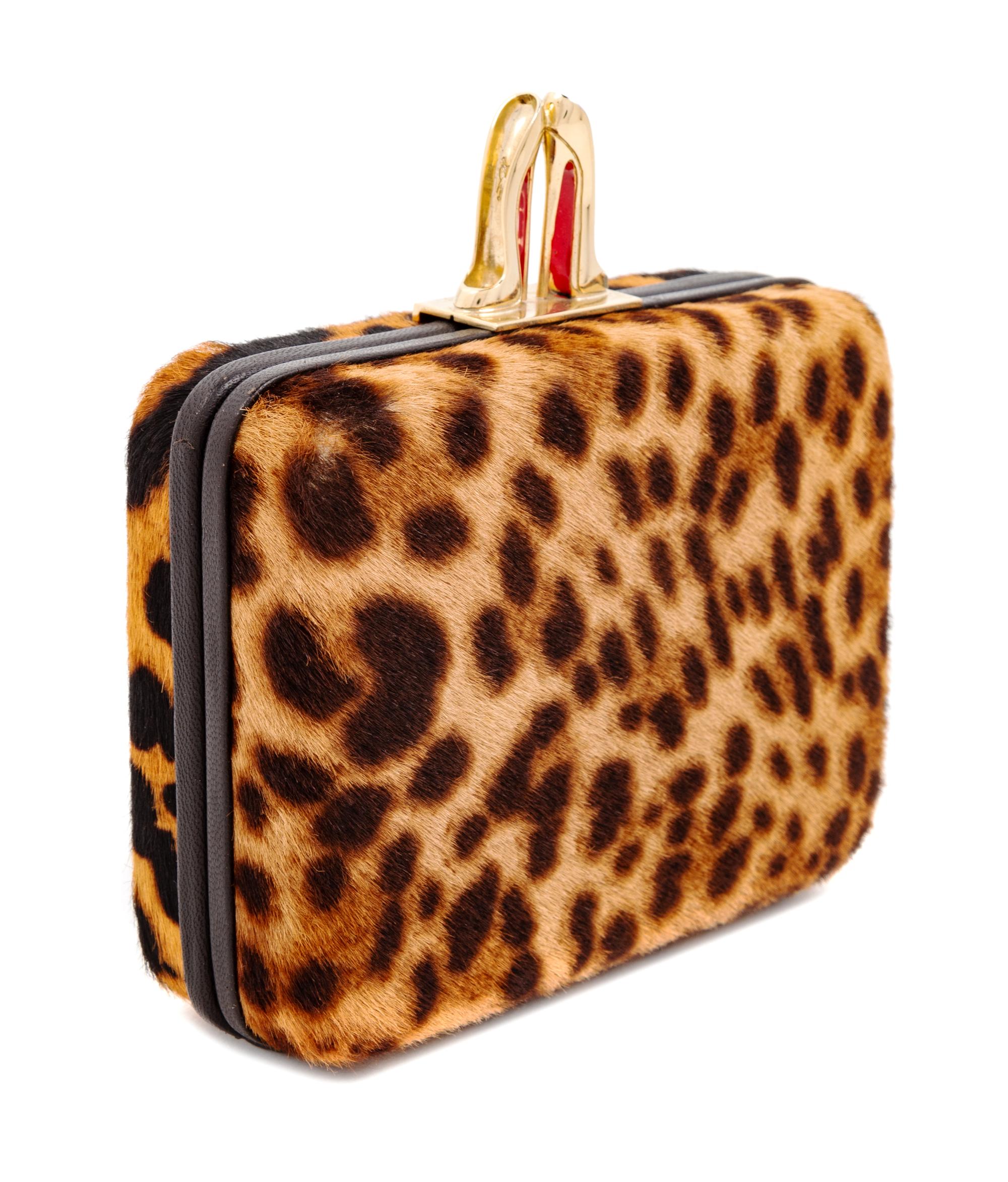A Christian Louboutin Leopard Print Pony Hair Clutch, 4" H x 5.5" W x 1.5" D.